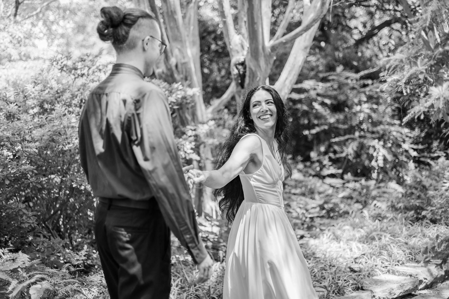 Black and white collage of wedding moments in a garden setting showing couple interacting and embracing during photo session.