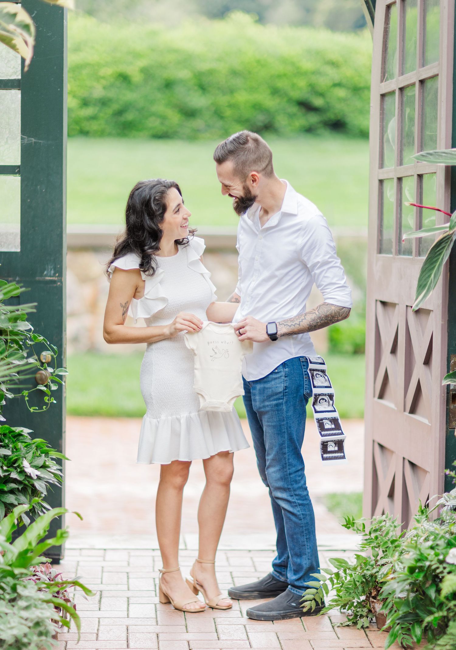A couple shares tender moments with their baby in a series of romantic outdoor photos on a covered porch.