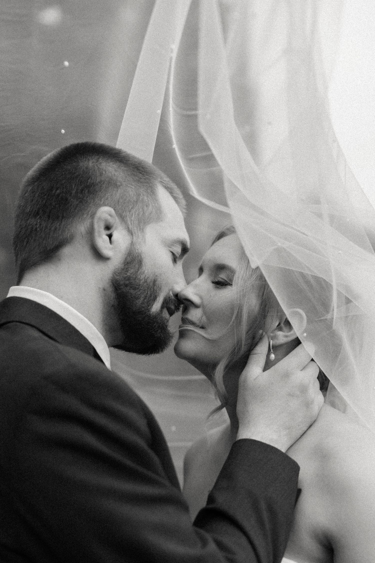Intimate black and white photo sequence capturing tender moments between newlyweds.