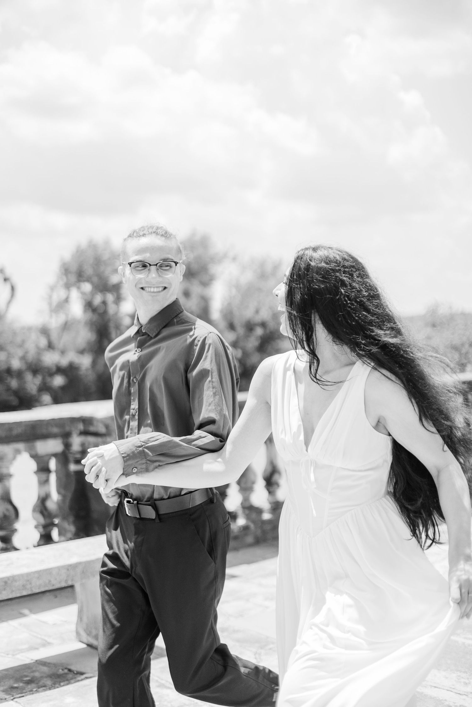 A black and white series shows a couple sharing intimate moments on an outdoor terrace.