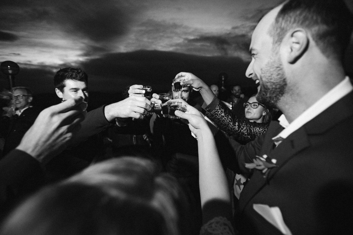Black and white sequence of celebratory moments at a wedding reception.