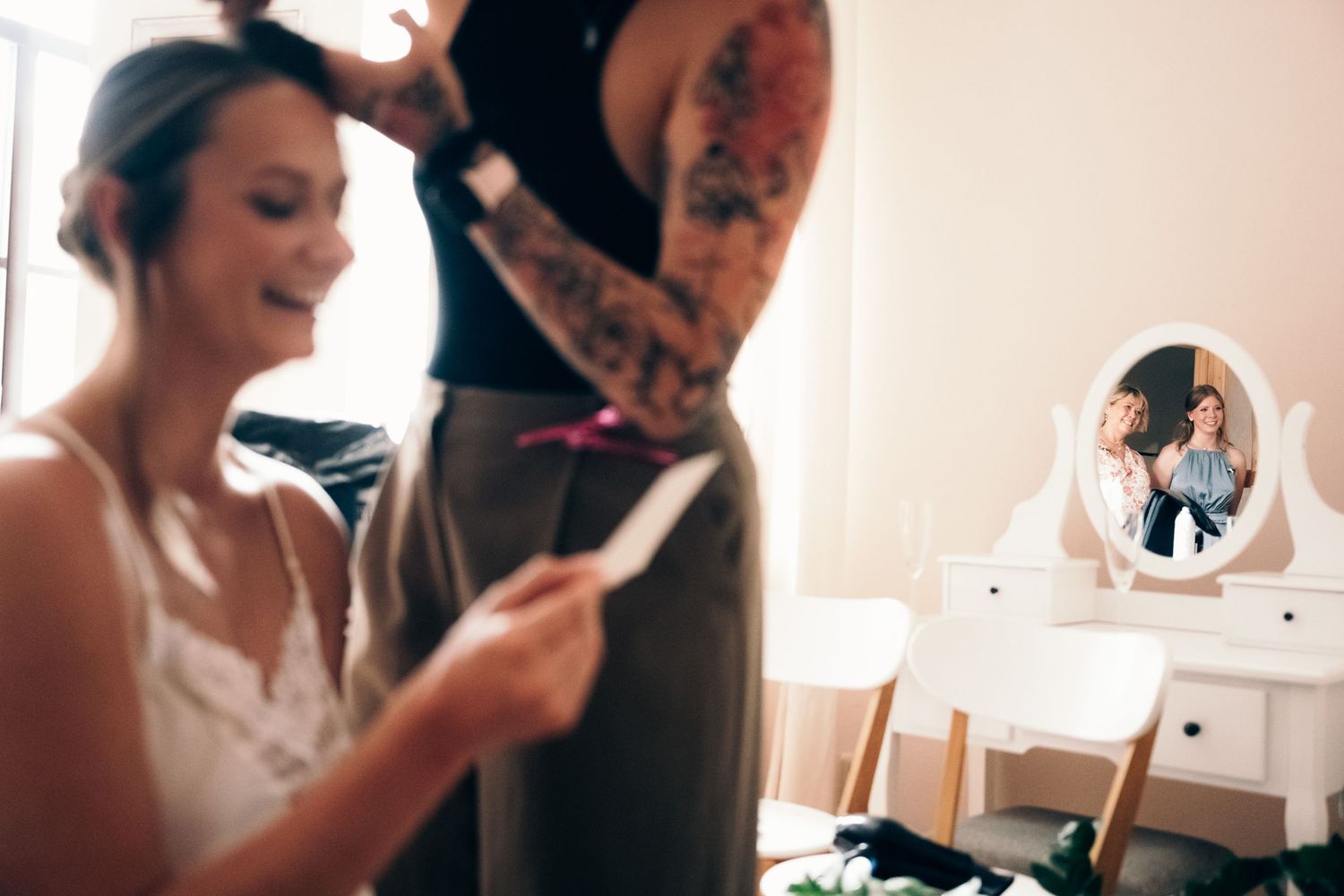 Intimate indoor wedding preparation moments captured in soft natural light.