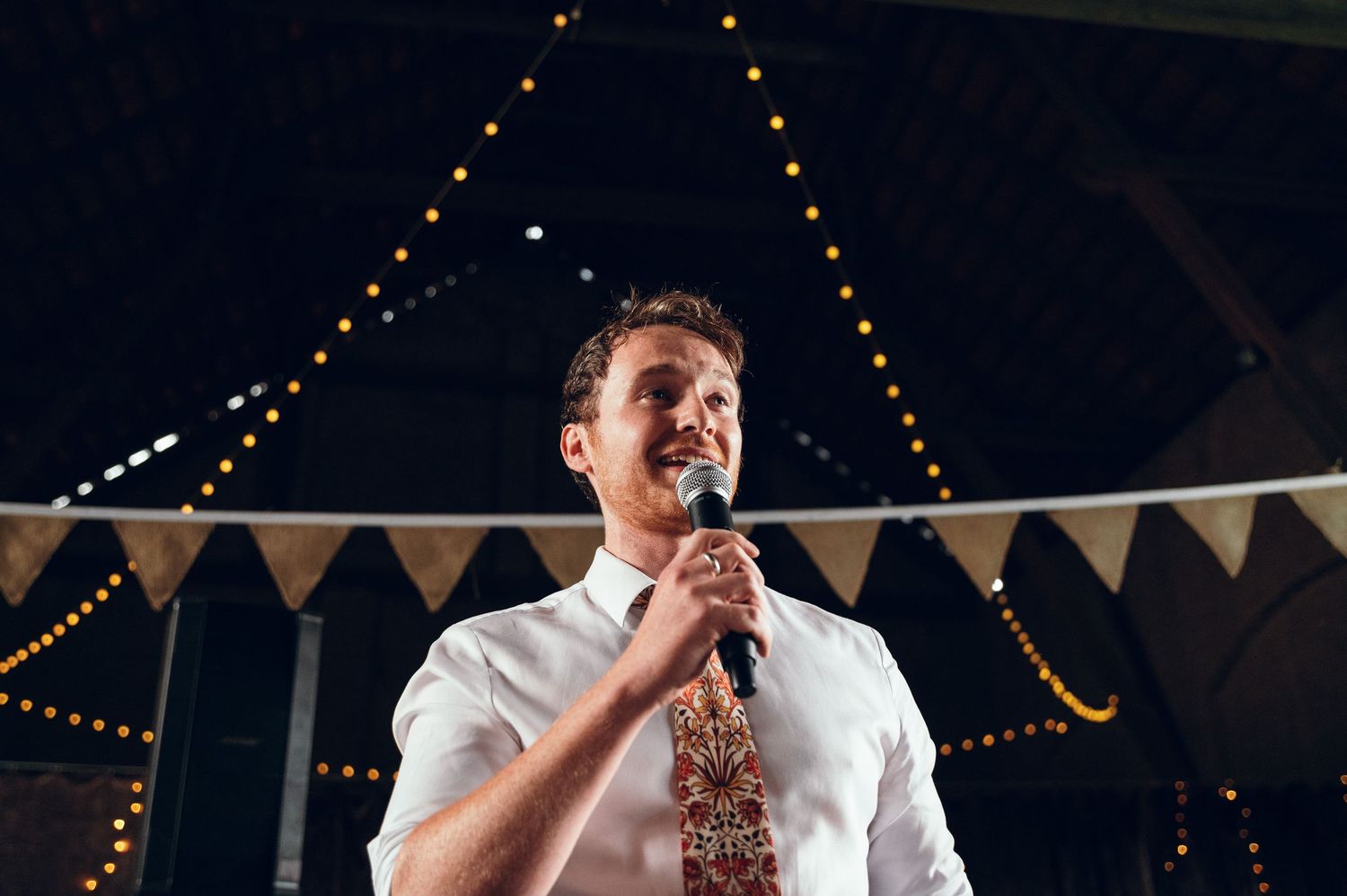 Wedding reception dance floor scenes with string lights and bunting decorations overhead.