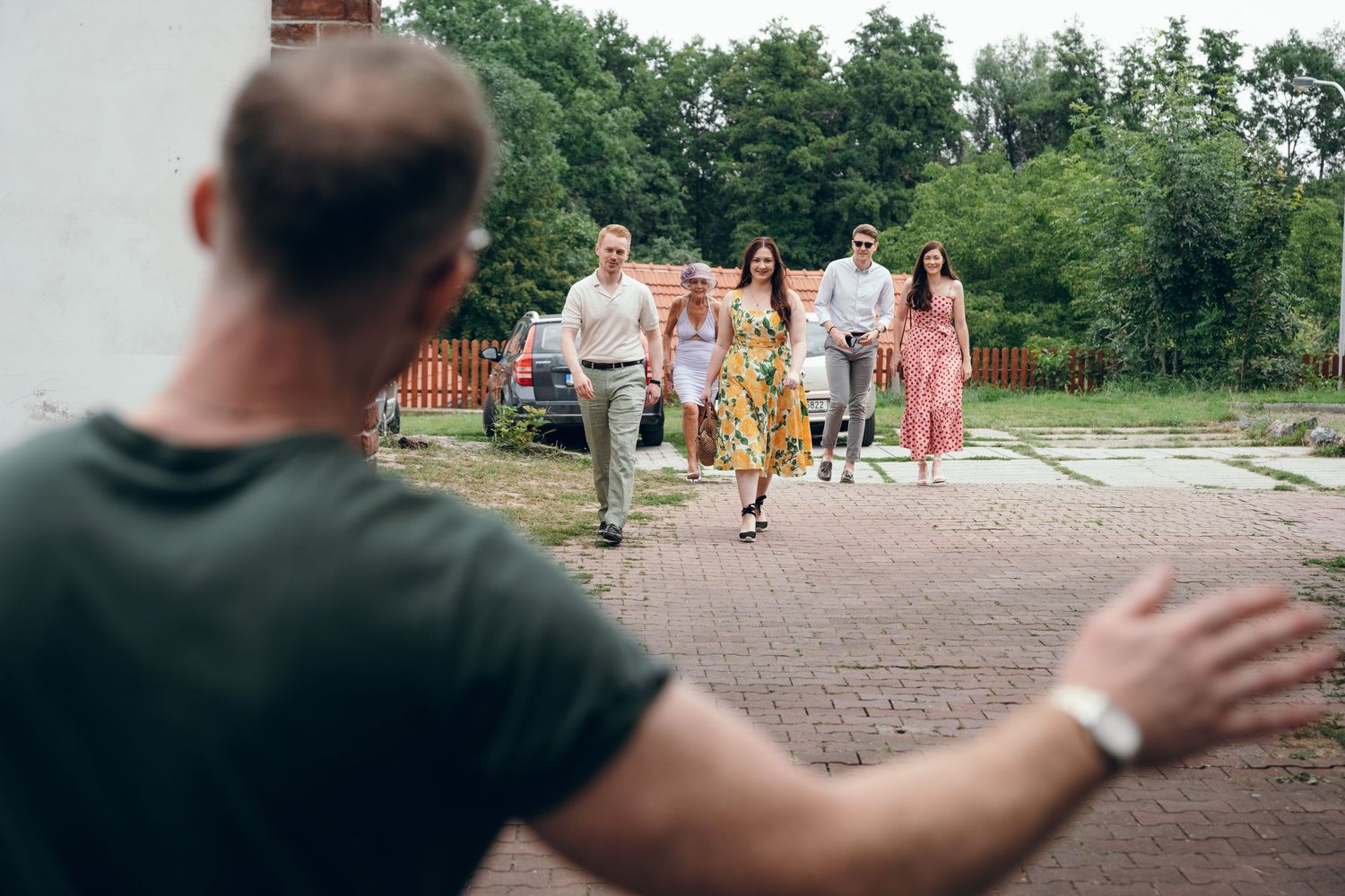 Wedding guests play outdoor lawn games during a summer celebration.