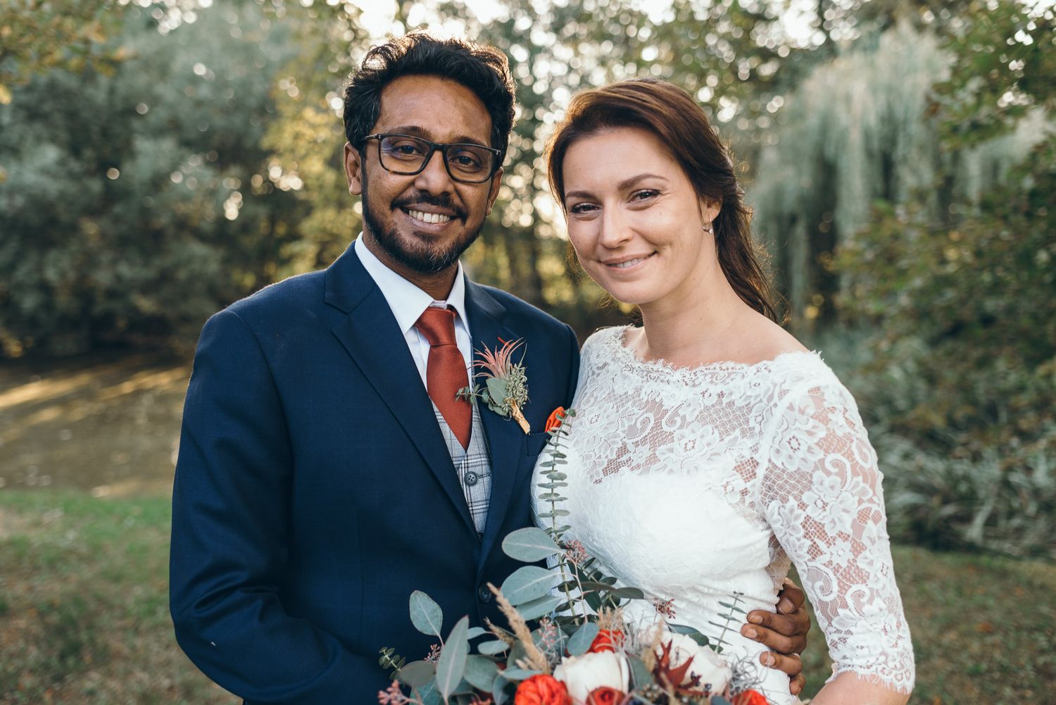 An intimate wedding celebration with a couple sharing joyful moments in an outdoor garden setting.