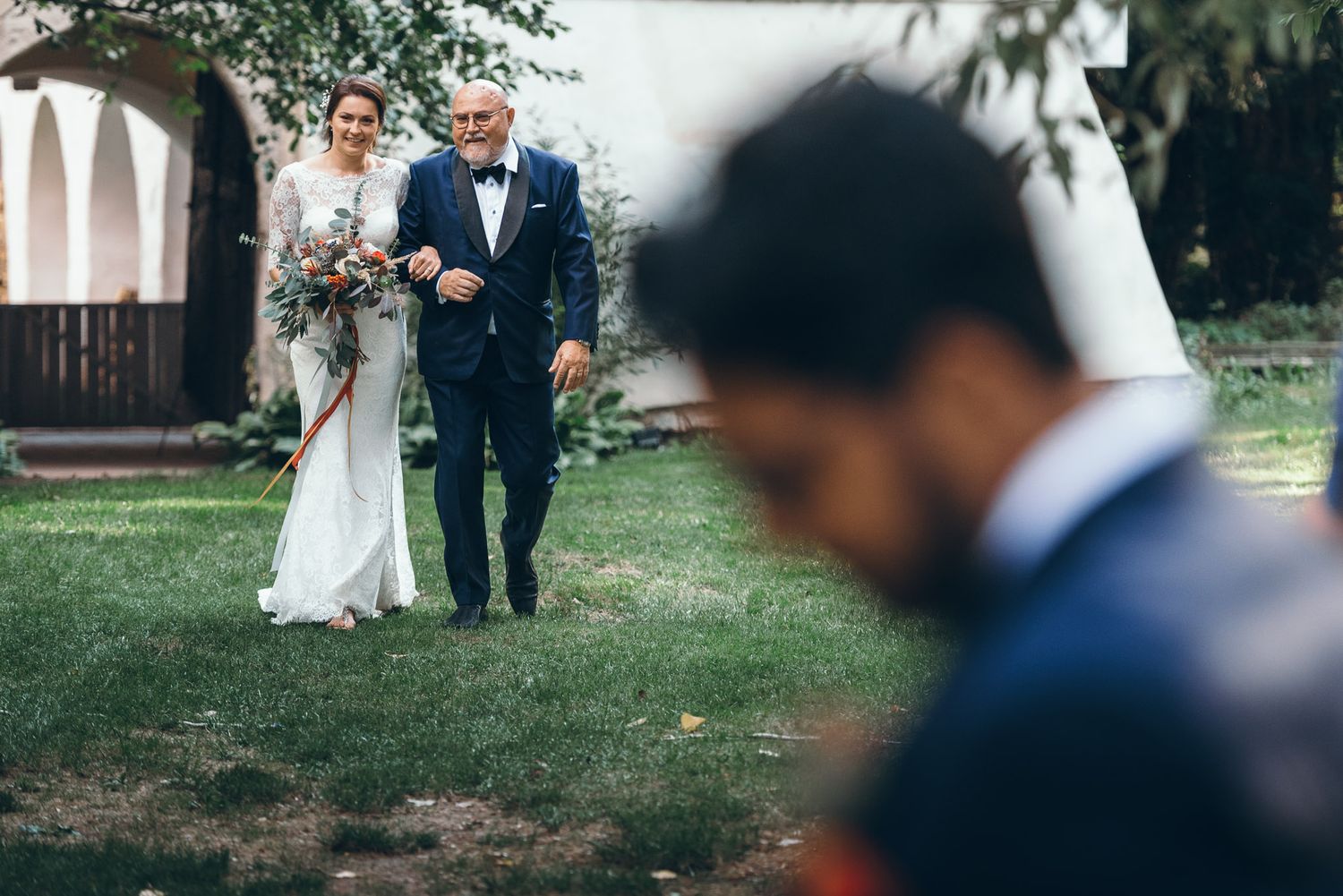 Candid moments captured during an outdoor wedding celebration in a garden setting.