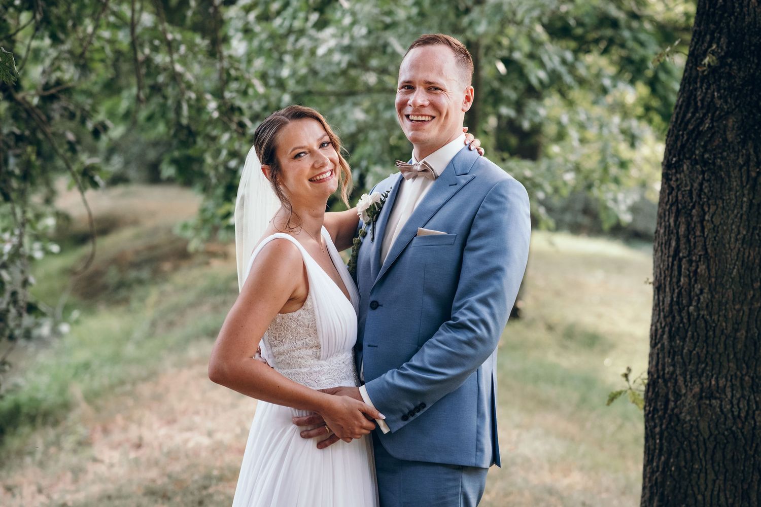 Romantic wedding portraits captured in outdoor garden setting.