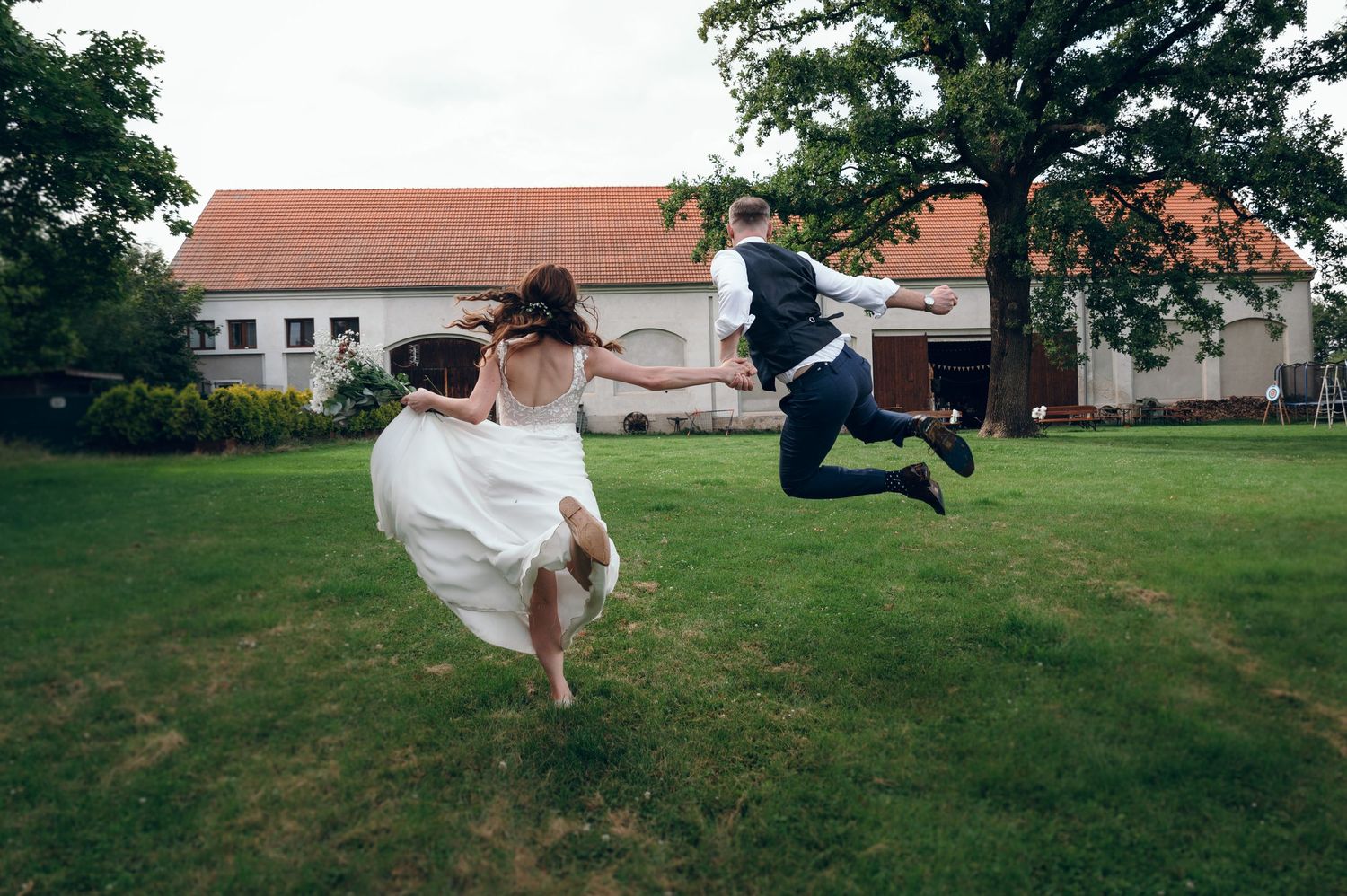 A series of outdoor wedding photos with a couple dancing and spinning in a garden setting.
