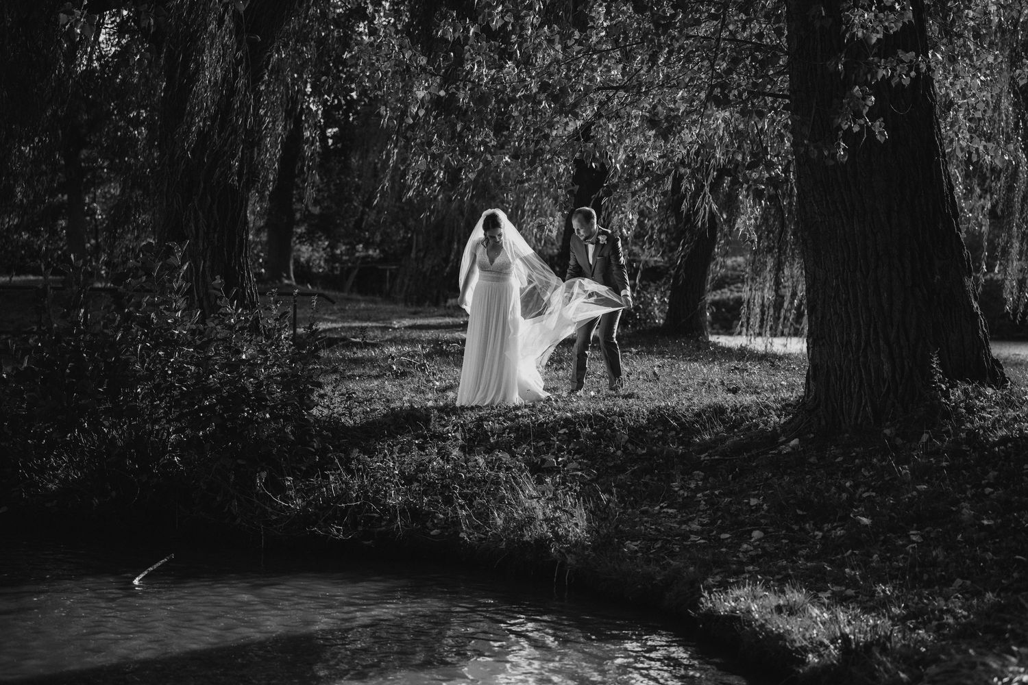 Black and white wedding photos showing movement and dancing in a romantic outdoor setting.