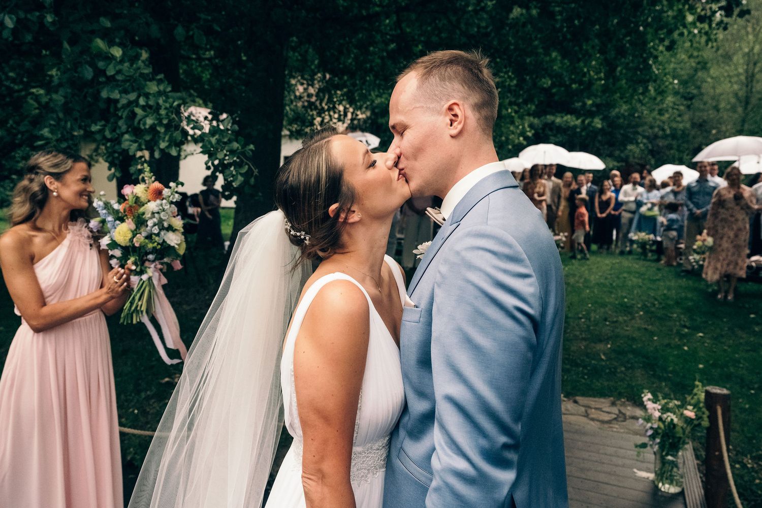 Candid moments captured during an outdoor summer wedding ceremony.