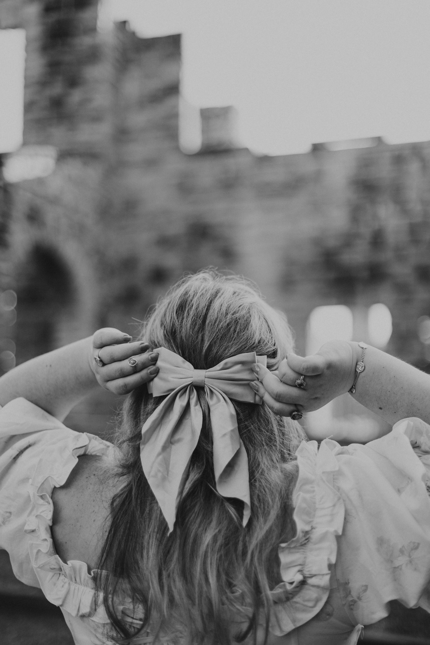 woman pulling on hair bow looking at castle ruins at Ha Ha Tonka