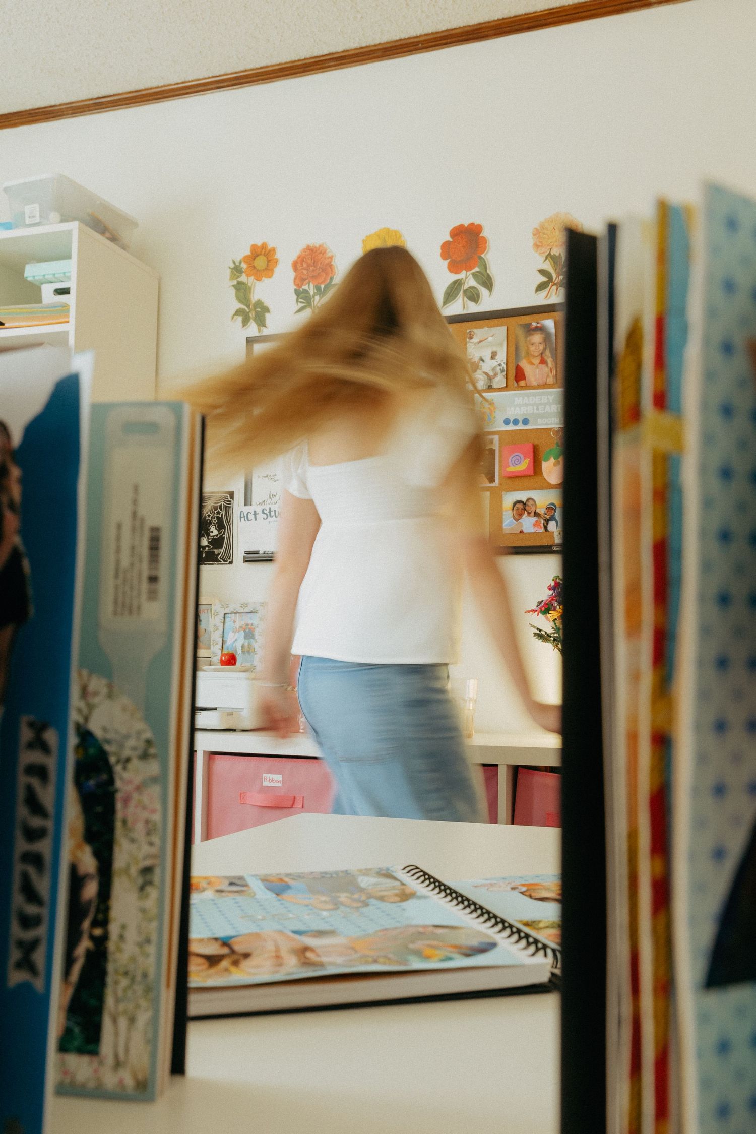 girl spinning in front of scrapbook pages motion blur