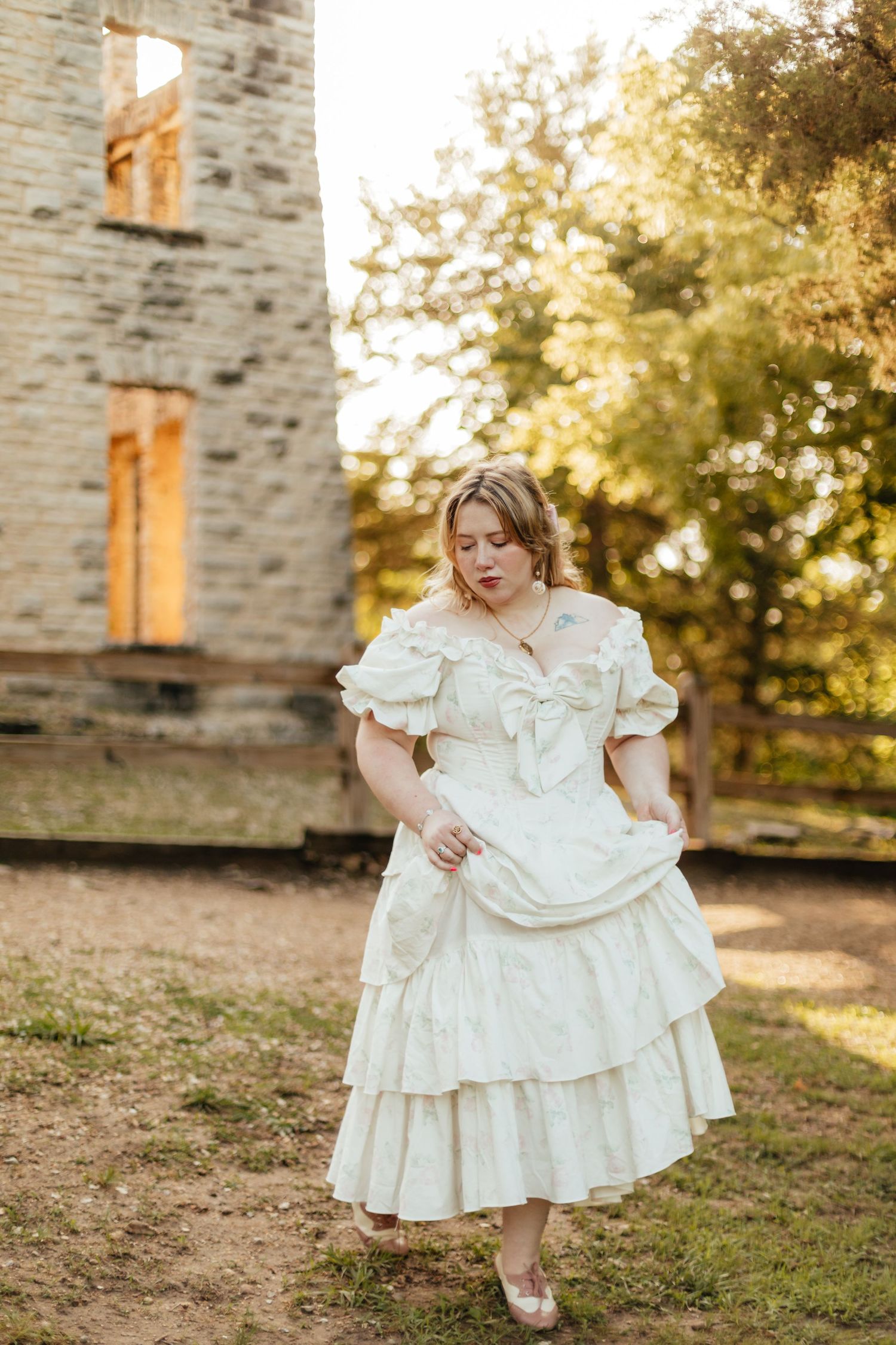 woman holding her dress skirt walking away from castle ruins at Ha Ha Tonka