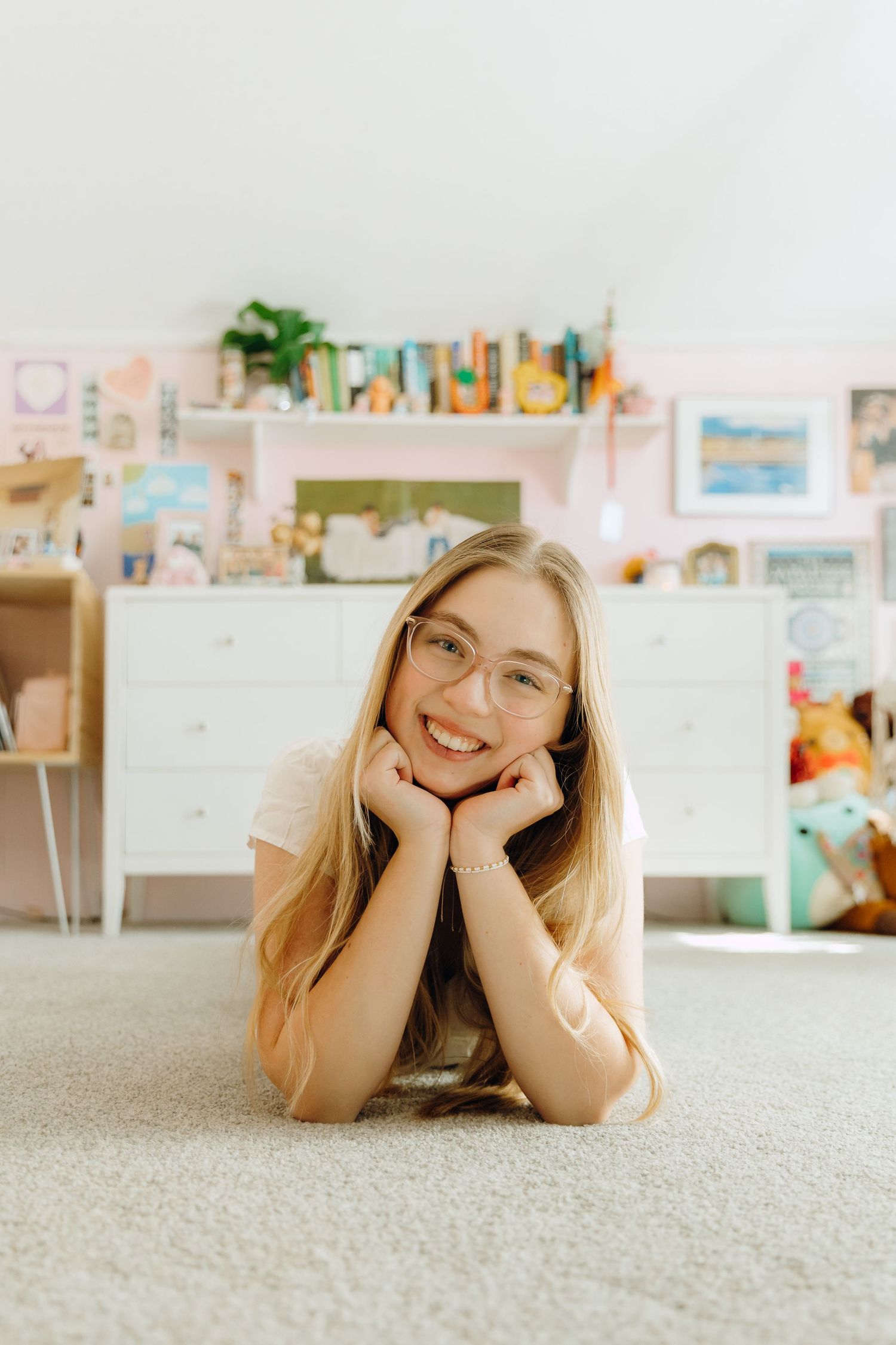 senior laying on floor in bedroom with decor behind her
