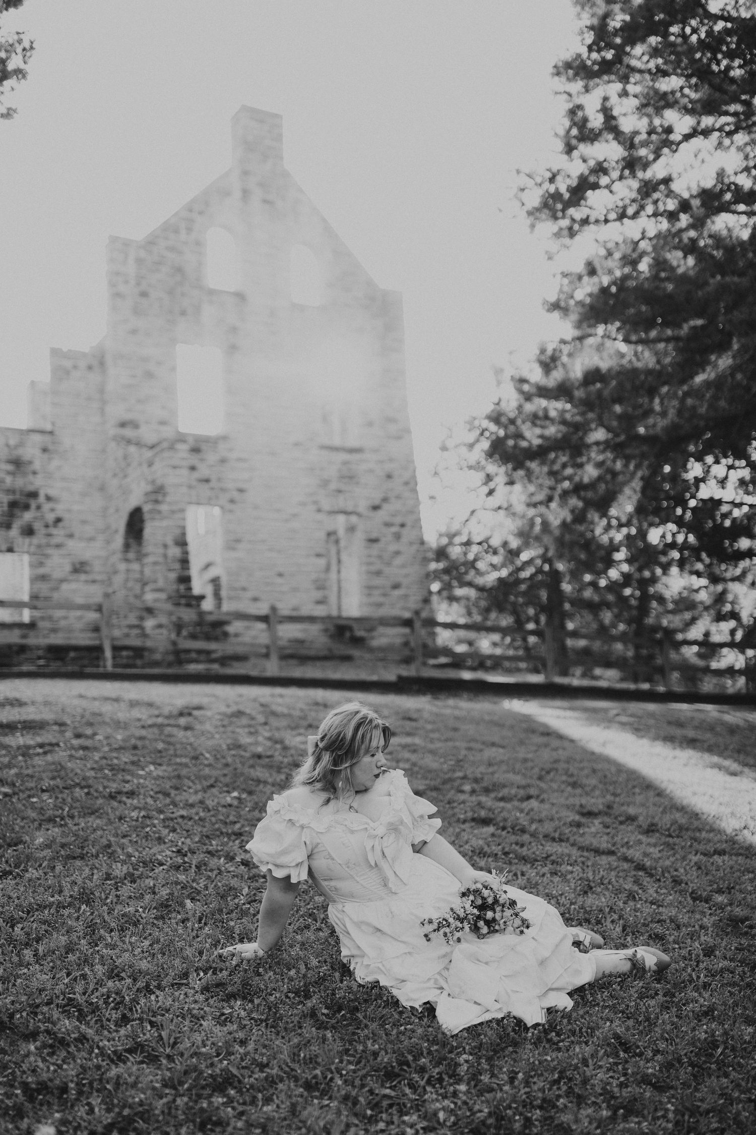 woman sitting in front of castle ruins at Ha Ha Tonka with frilly dress and dried flowers