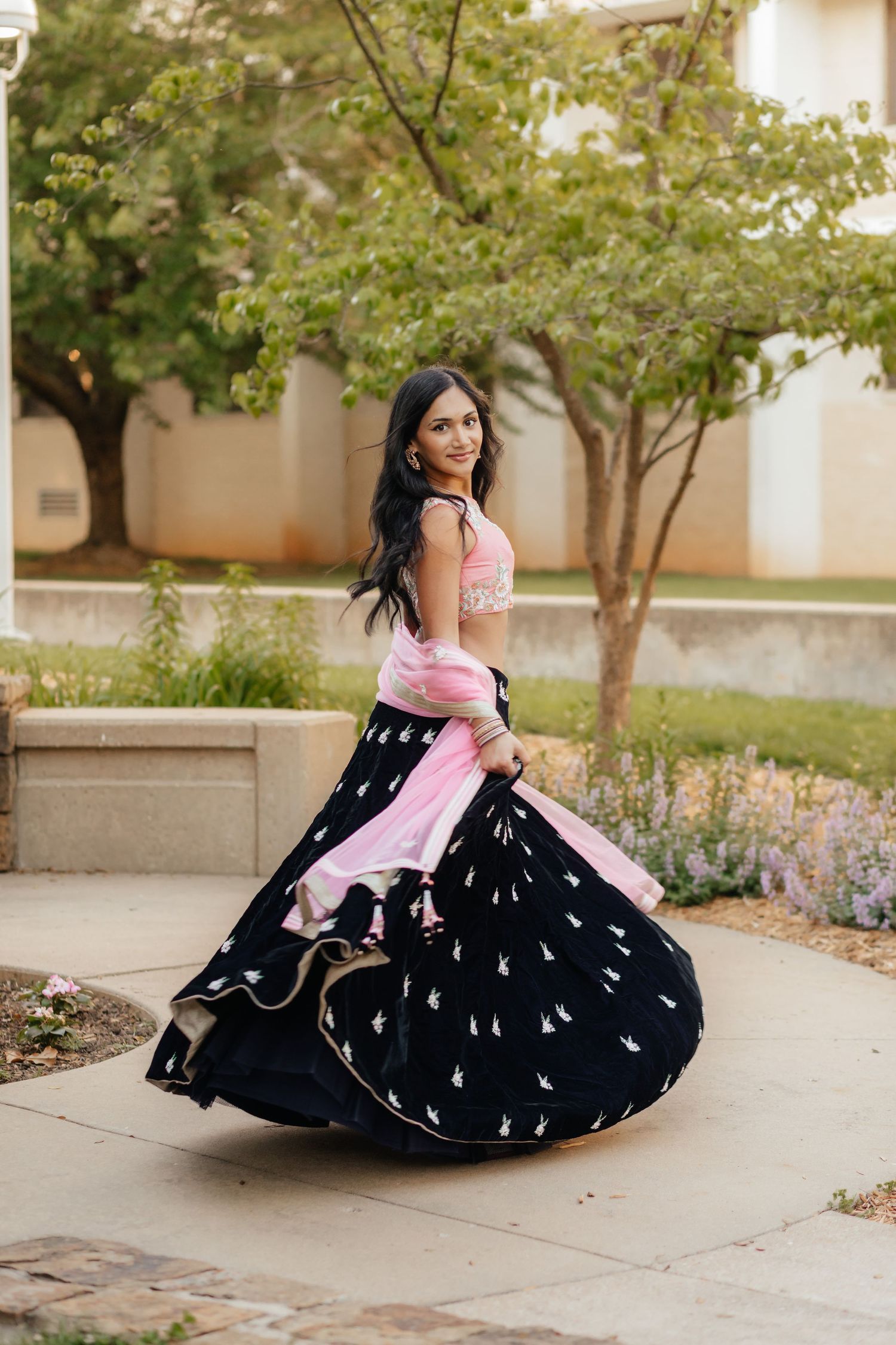 grad in lehenga spinning around on MSU campus