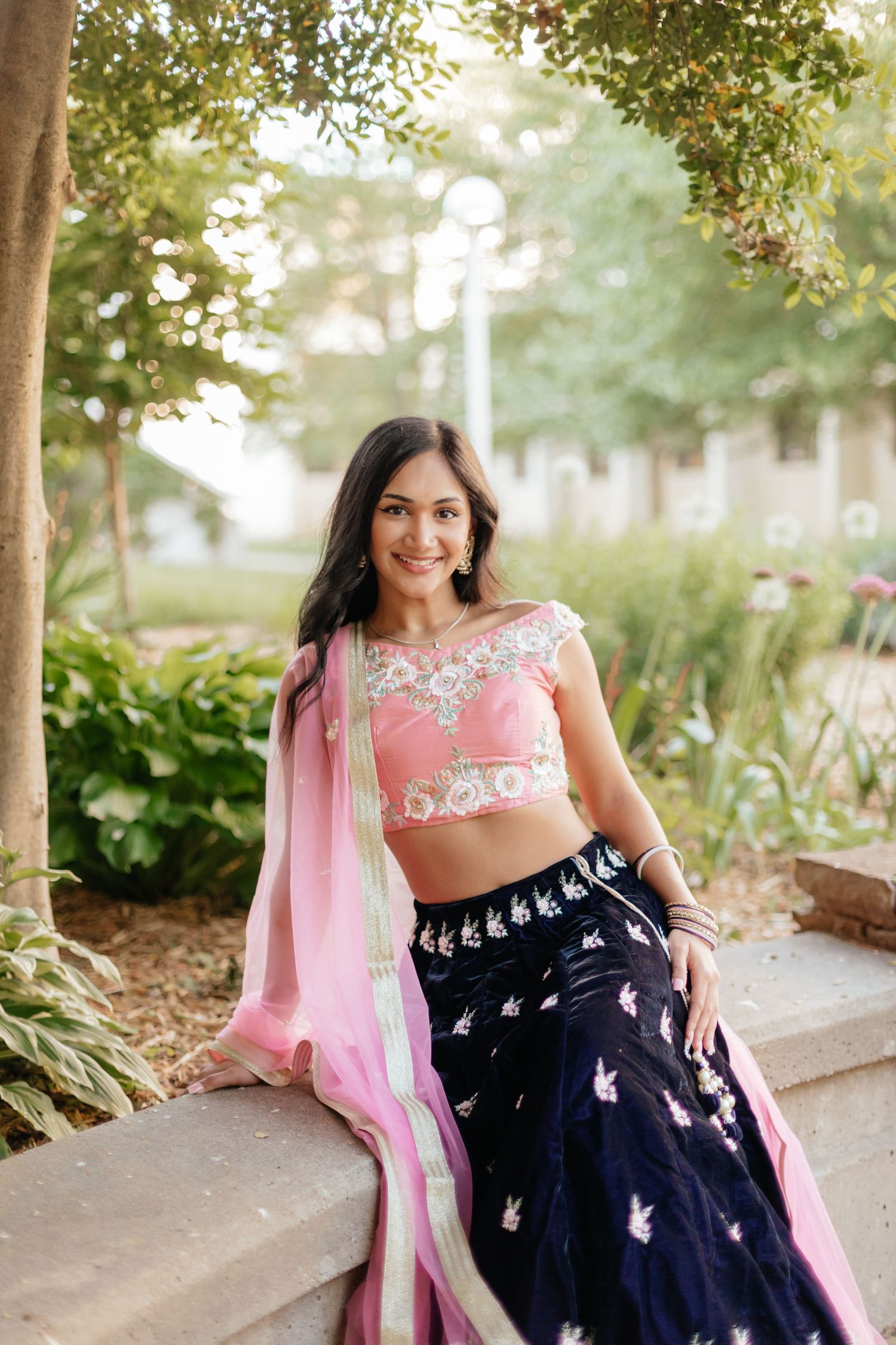 woman posing on ledge wearing traditional lehenga outfit at MSU