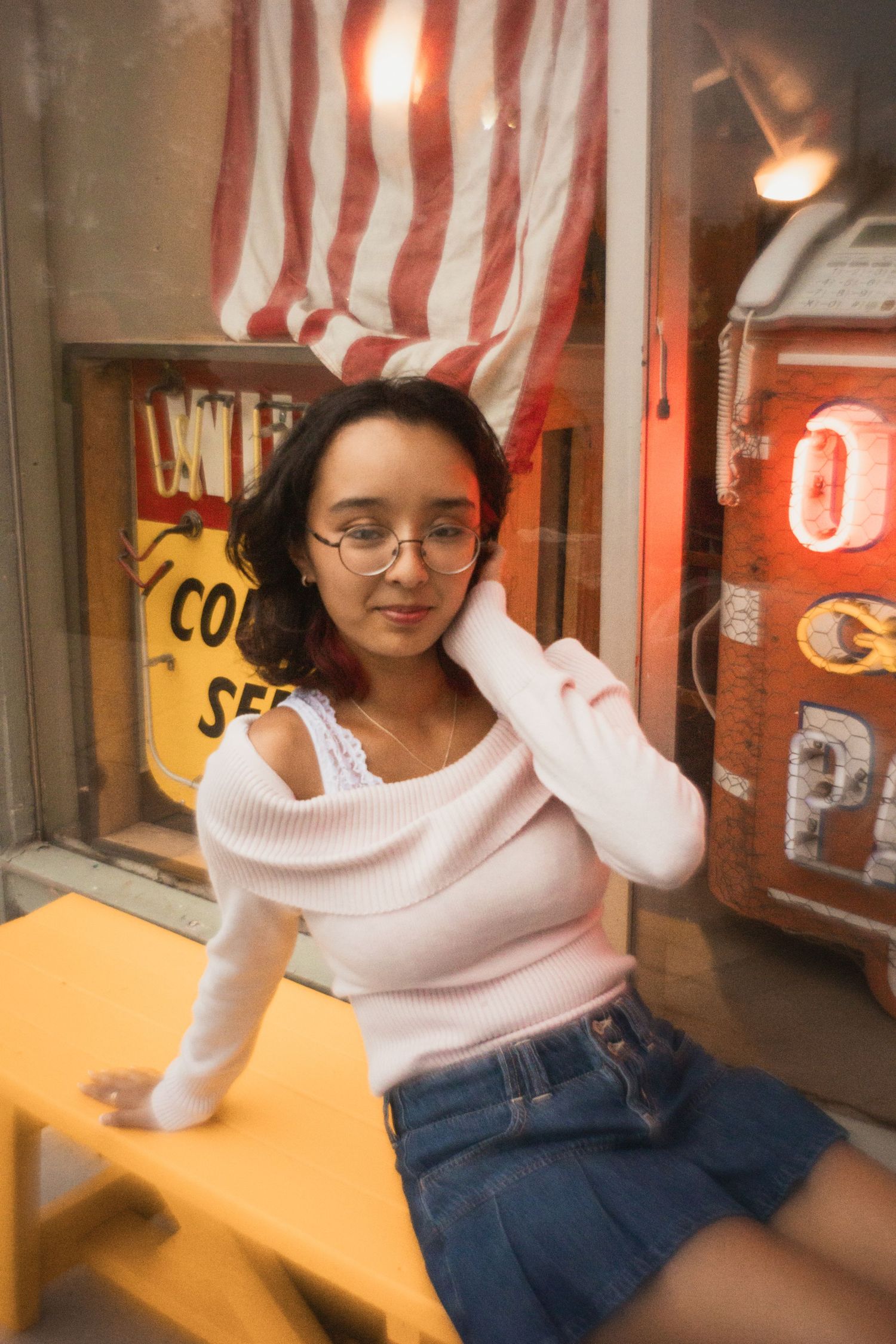 film senior photo on commercial street in front of store window