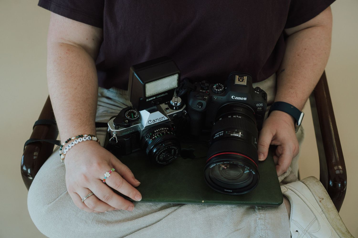 laptop, camera, and film camera in a lap
