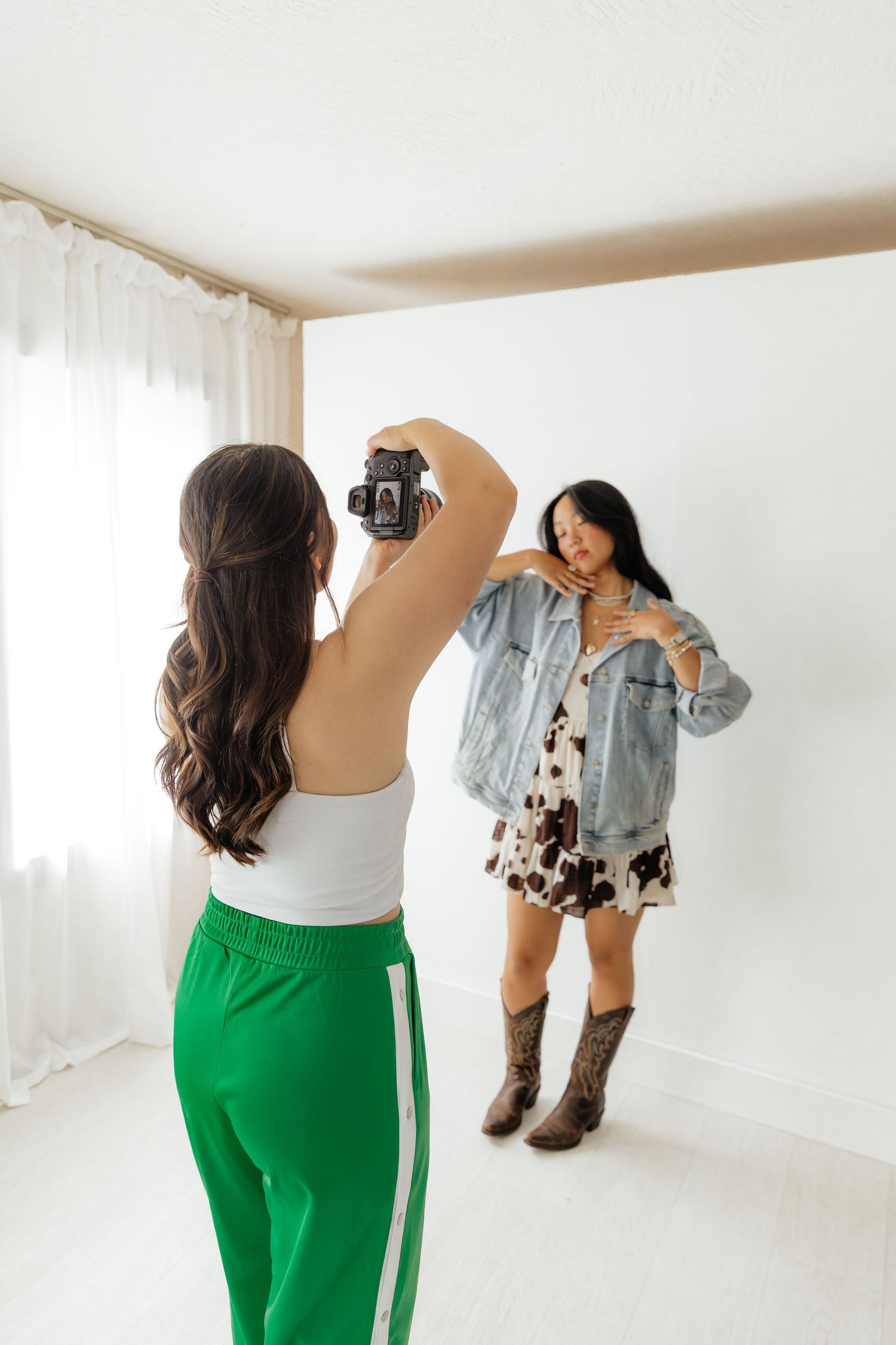 photographer taking photo of girl in cow print dress and denim jacket at Lightbox in Springfield, MO