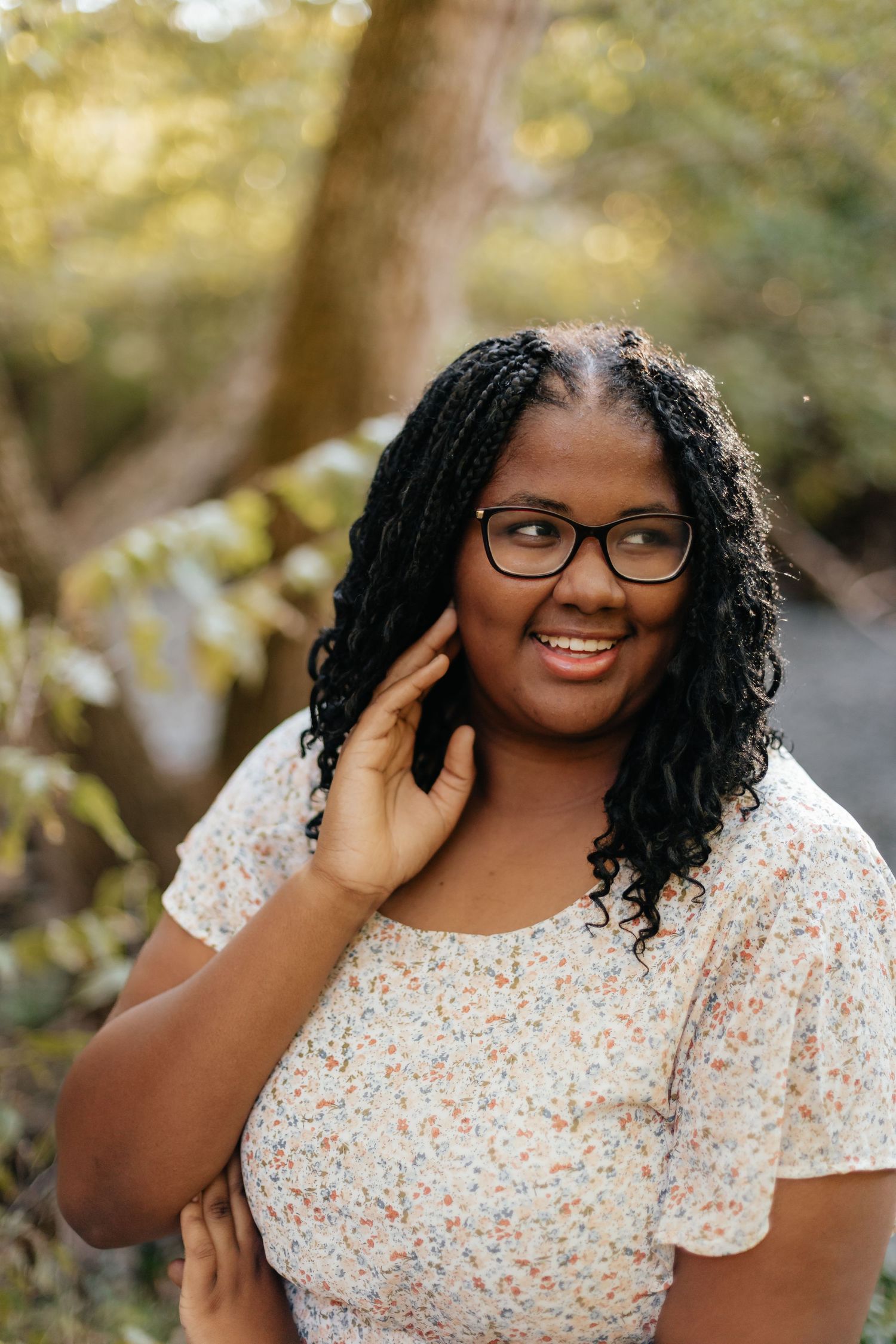 outdoor fall senior photos of girl in yellow floral dress