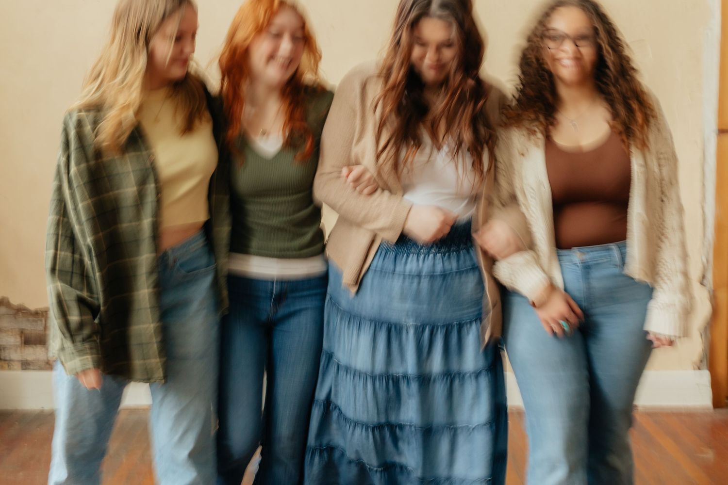 group of 4 girls walking towards camera with motion blur