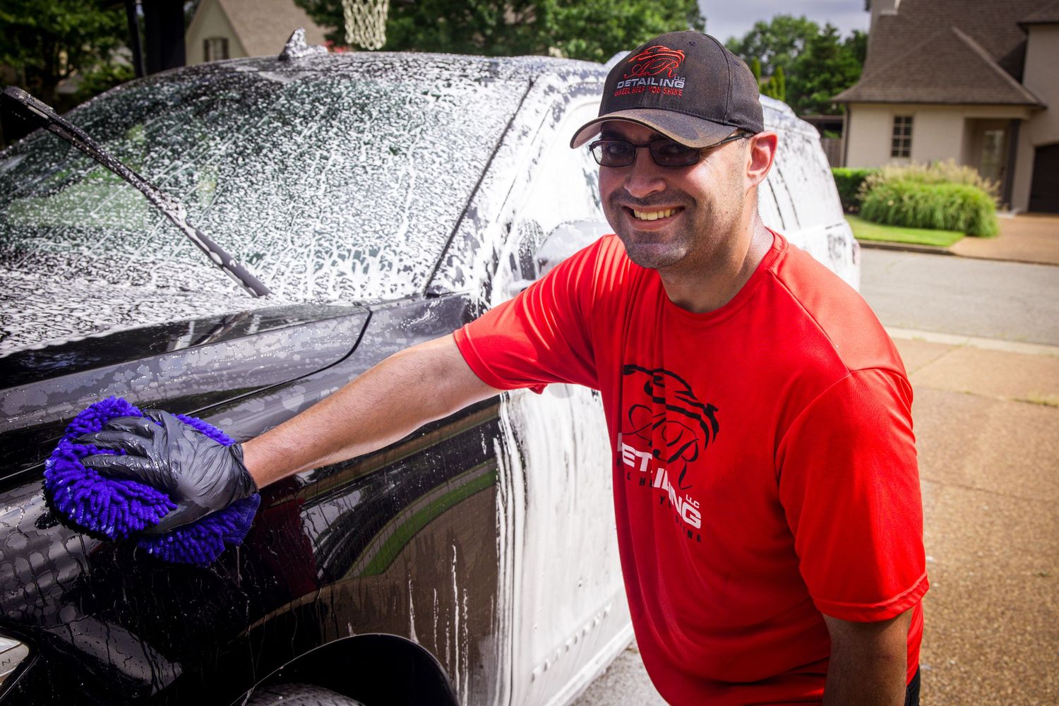 Car detailing sequence showing washing, scrubbing, and cleaning steps on a vehicle exterior with soap and brushes.