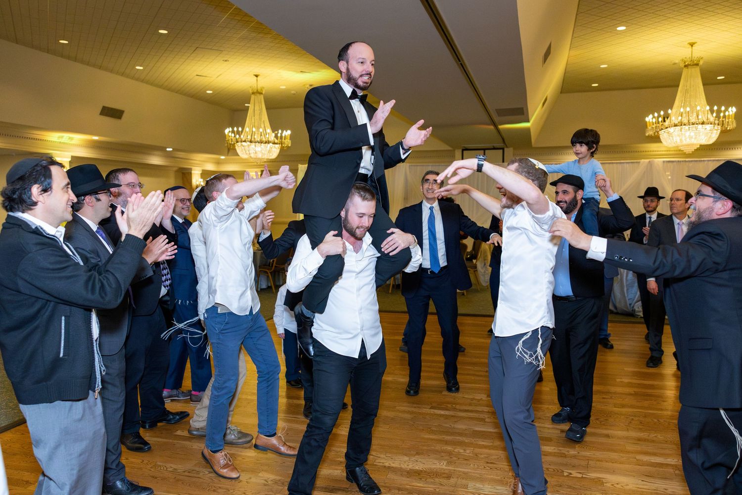 Wedding reception dance floor filled with guests enjoying the celebration.