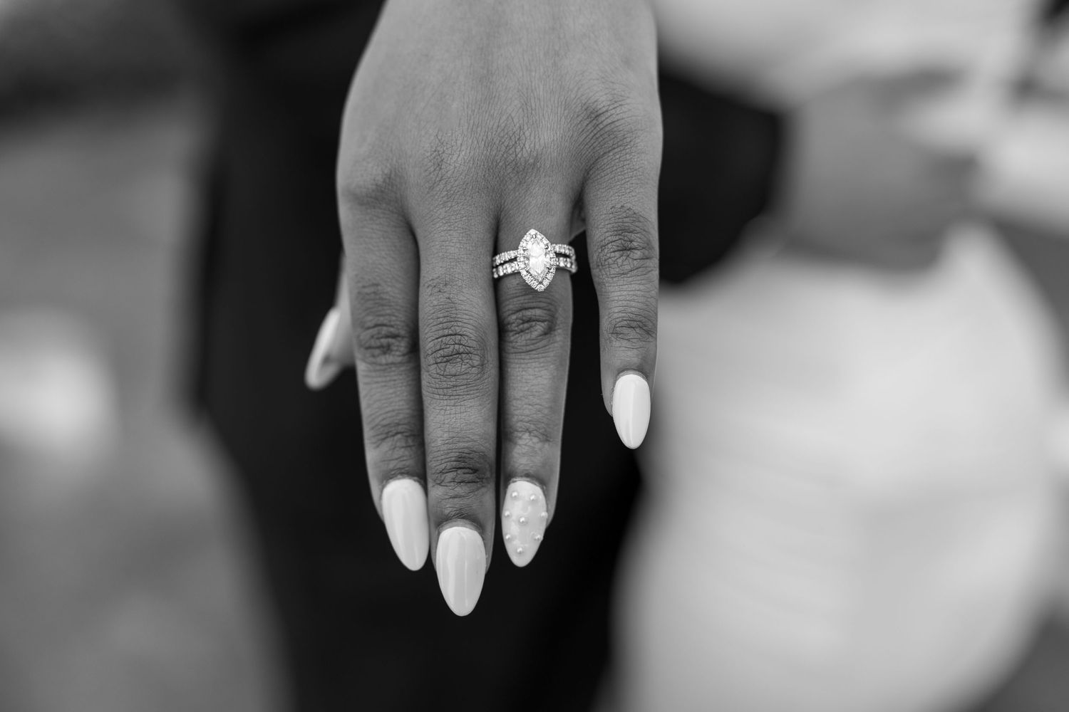 Close-up shots of elegant wedding rings and manicured hands.