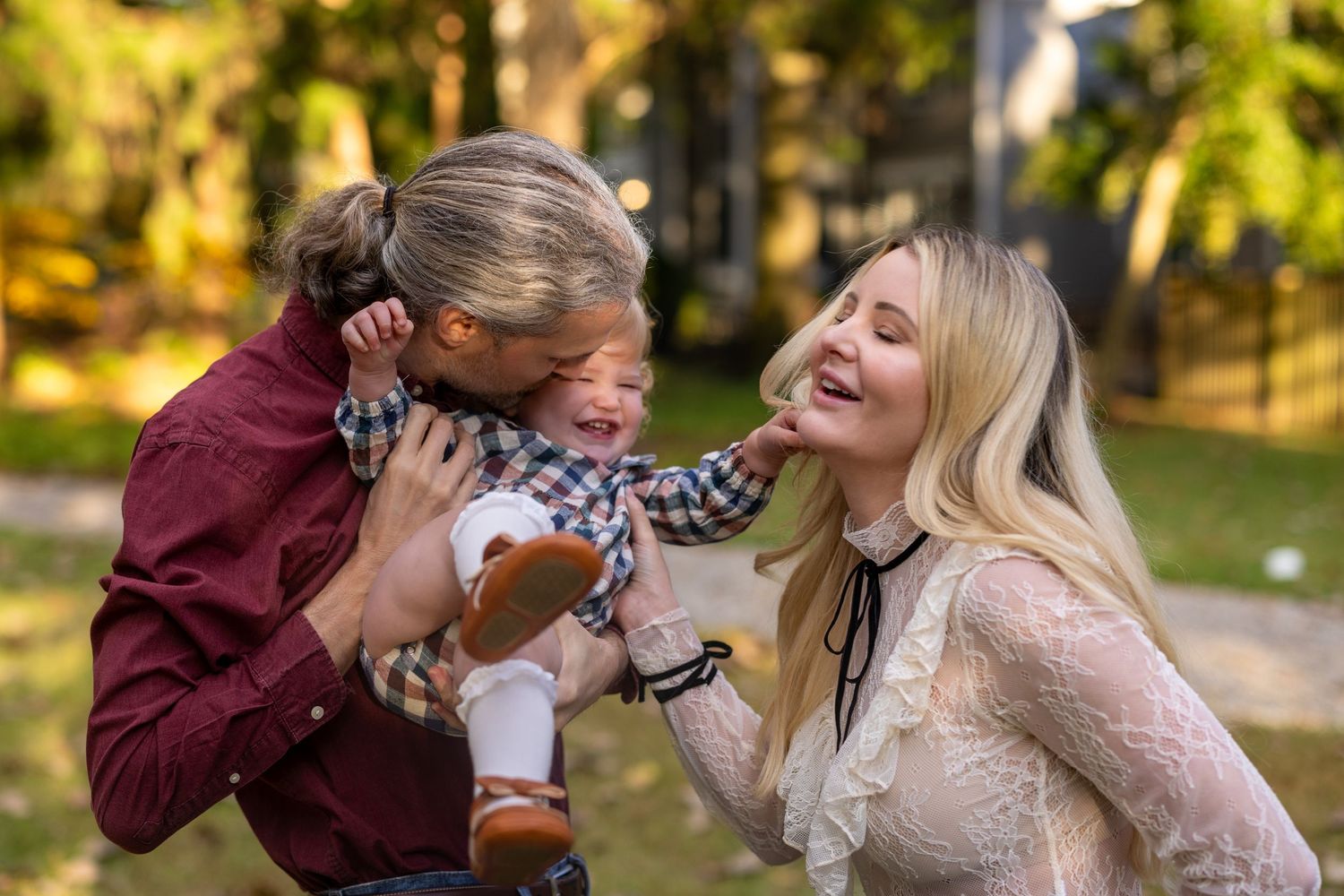 Joyful outdoor family moment captured in golden autumn light.