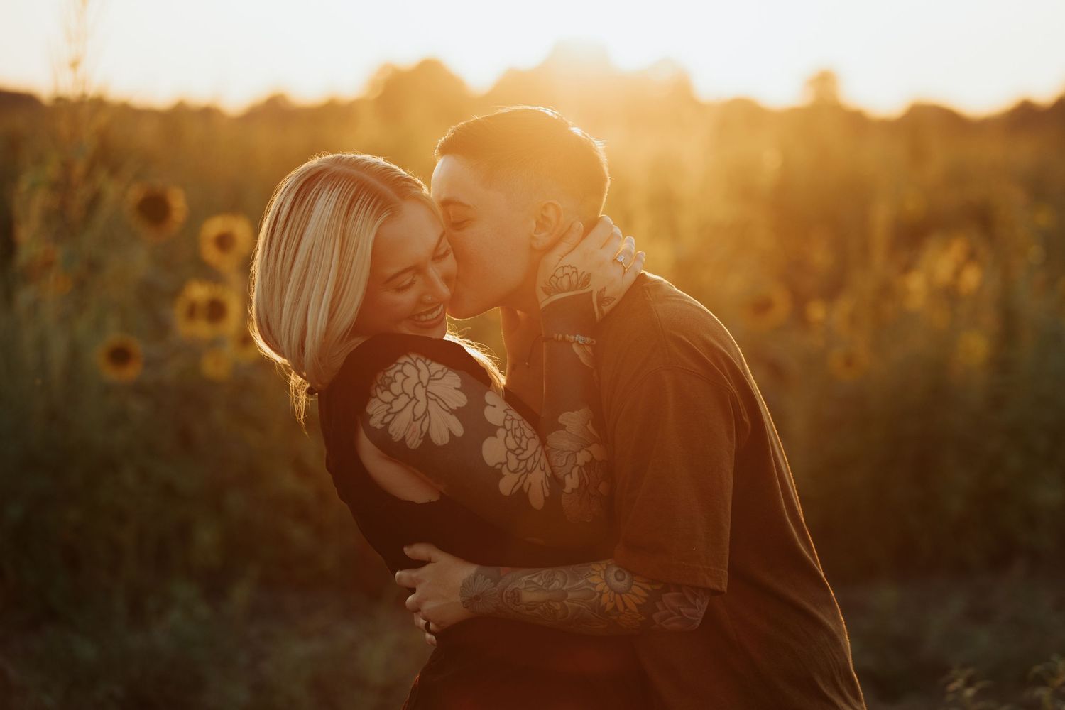 Magical golden hour light captures an intimate moment in a blooming sunflower field.