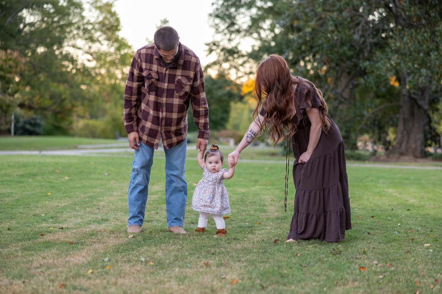 A family enjoying time together in a park during sunset.