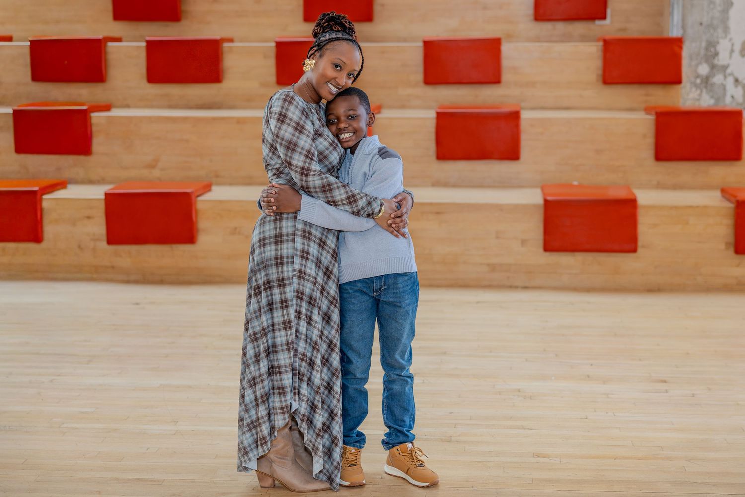 Family photoshoot in contemporary indoor space with geometric red wall design.