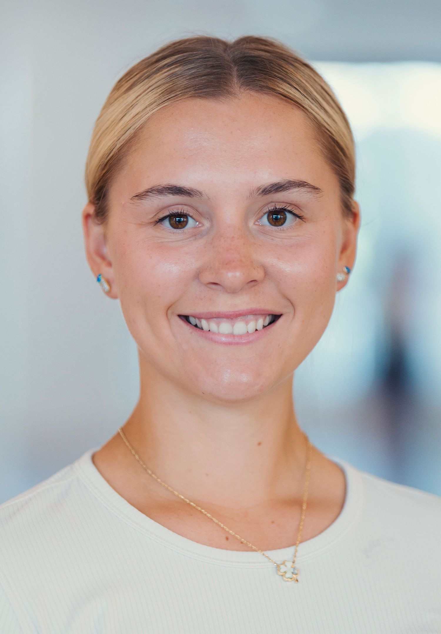 Bright professional headshots with natural lighting and white attire.