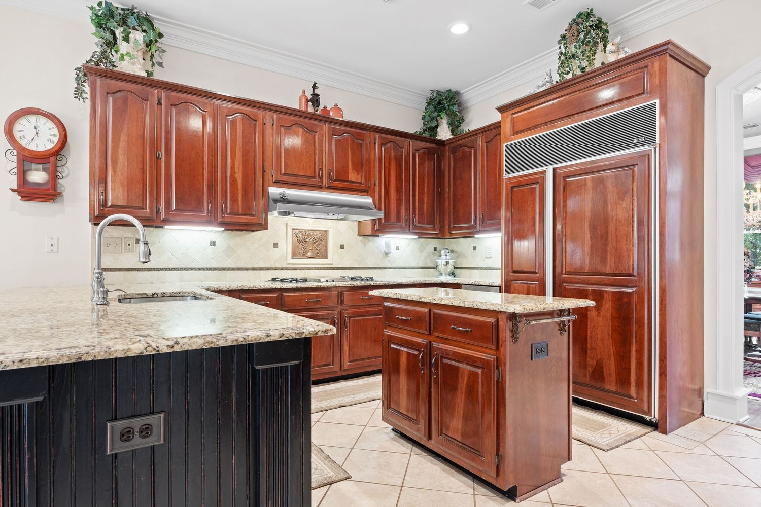 Luxury kitchen with cherry wood cabinets, granite countertops, and stainless steel appliances.