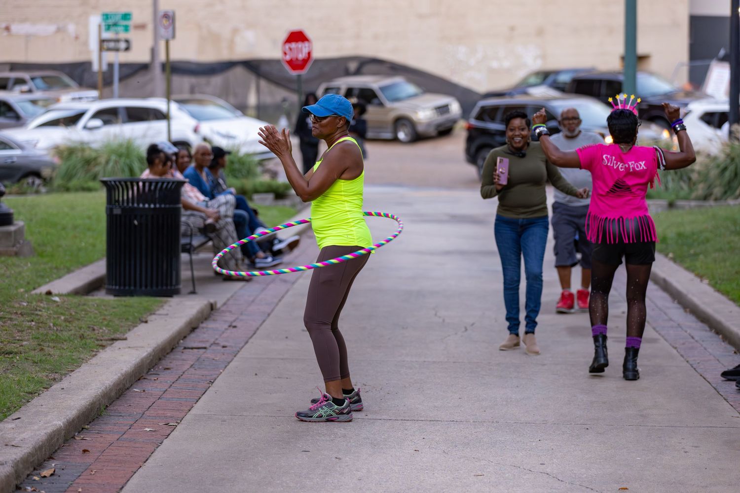 People walking and gathering on a paved pathway during an outdoor event.