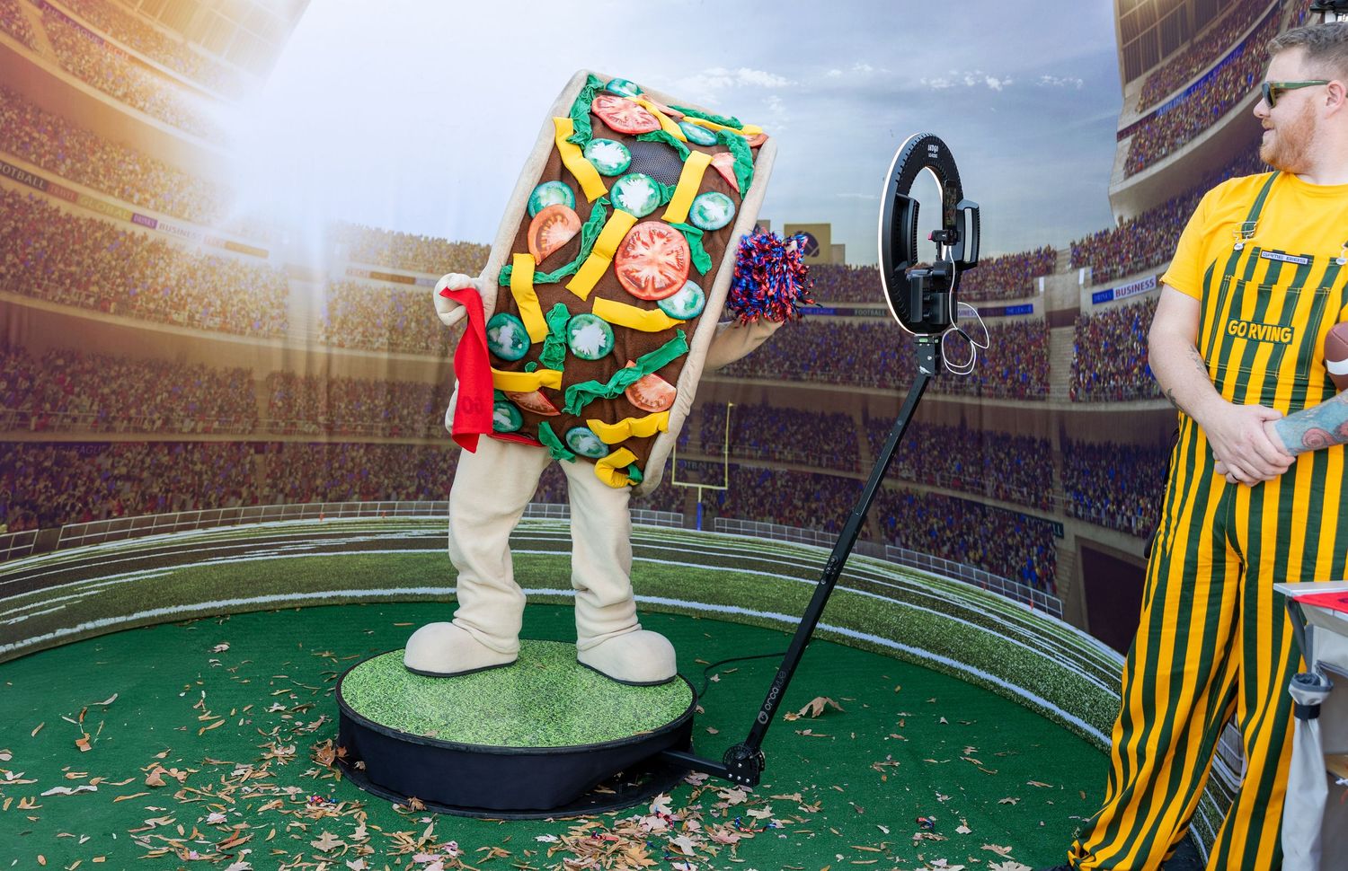 Stadium field with colorful confetti scattered across artificial turf surface.