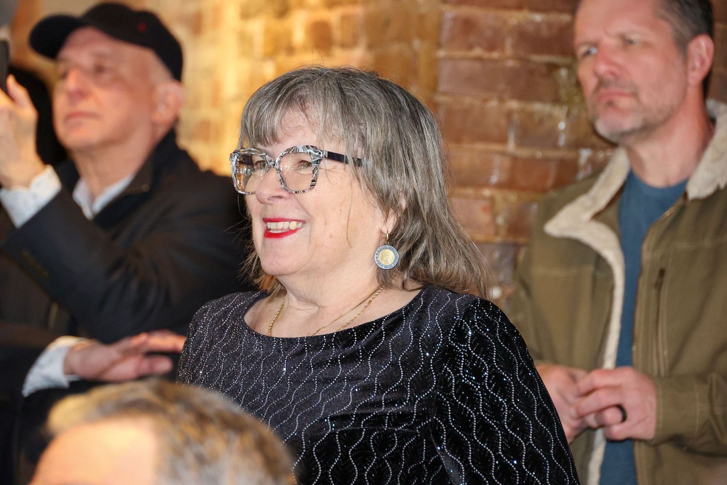 Performers engaging with audience during live musical show.