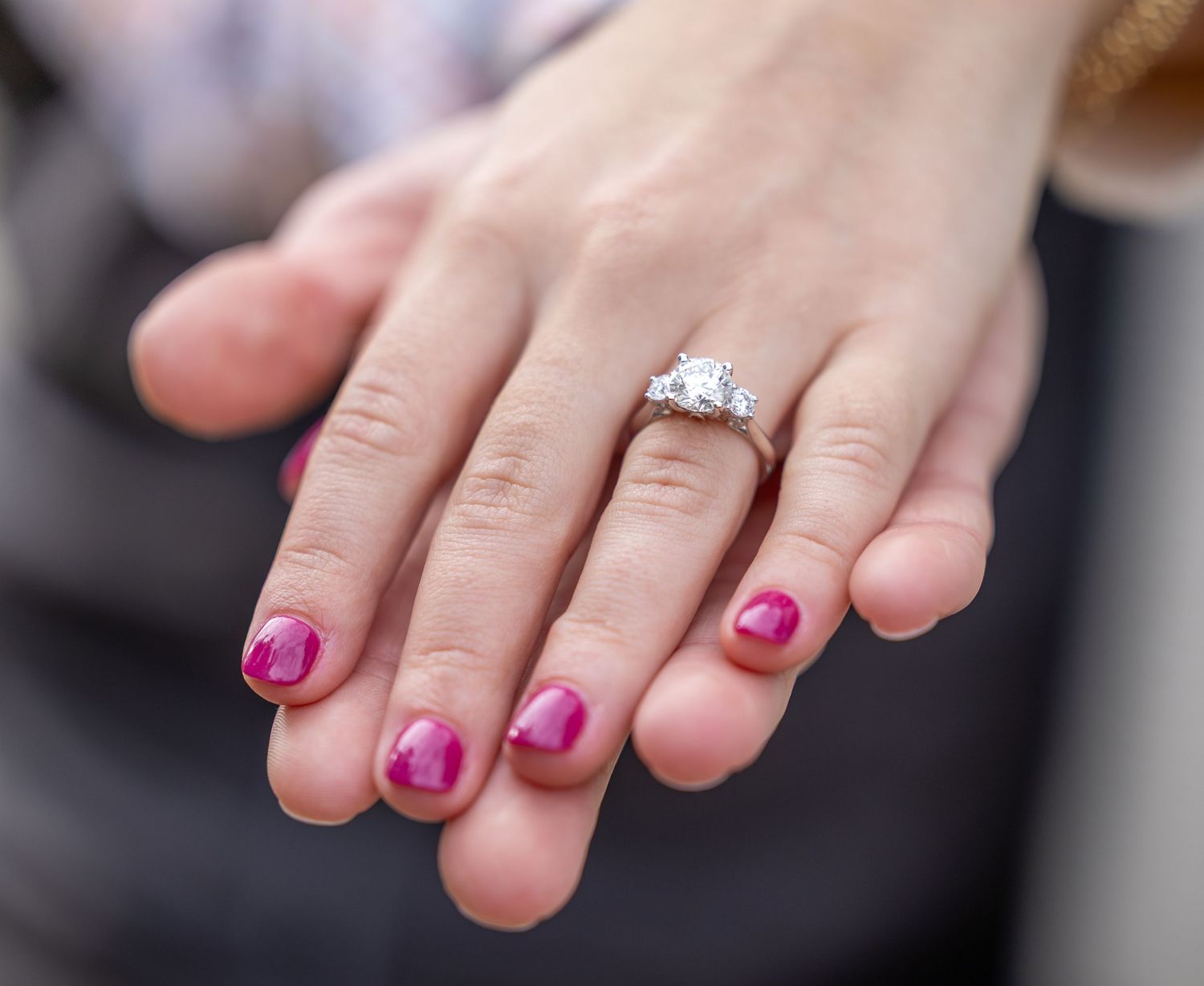 Close-up sequence showing pink painted toenails and a diamond engagement ring on a woman's foot.