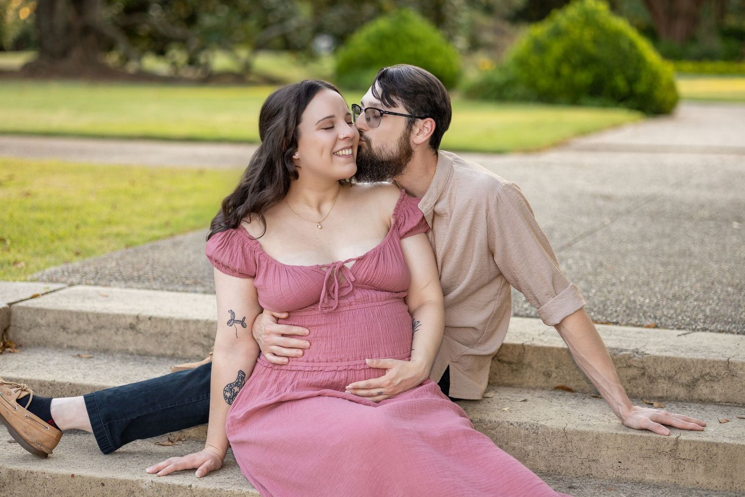 Romantic outdoor portrait in a park setting during golden hour.