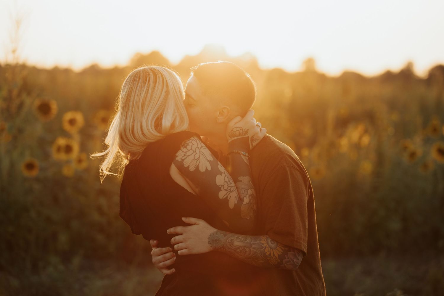 Sunset casts a warm glow over a romantic scene in a summer sunflower garden.
