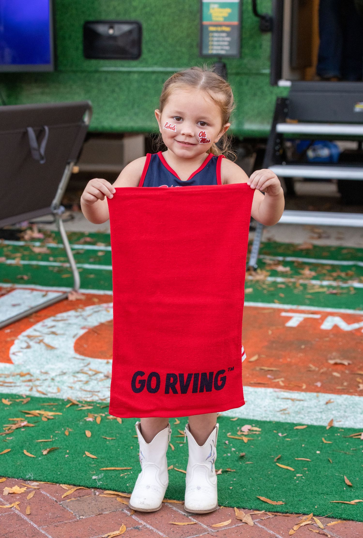 Red rally towels with team spirit messages displayed at sporting event.