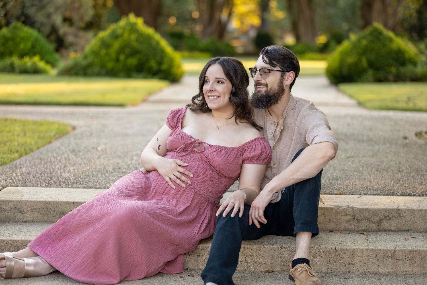 Intimate outdoor portrait session on concrete steps with warm evening lighting.