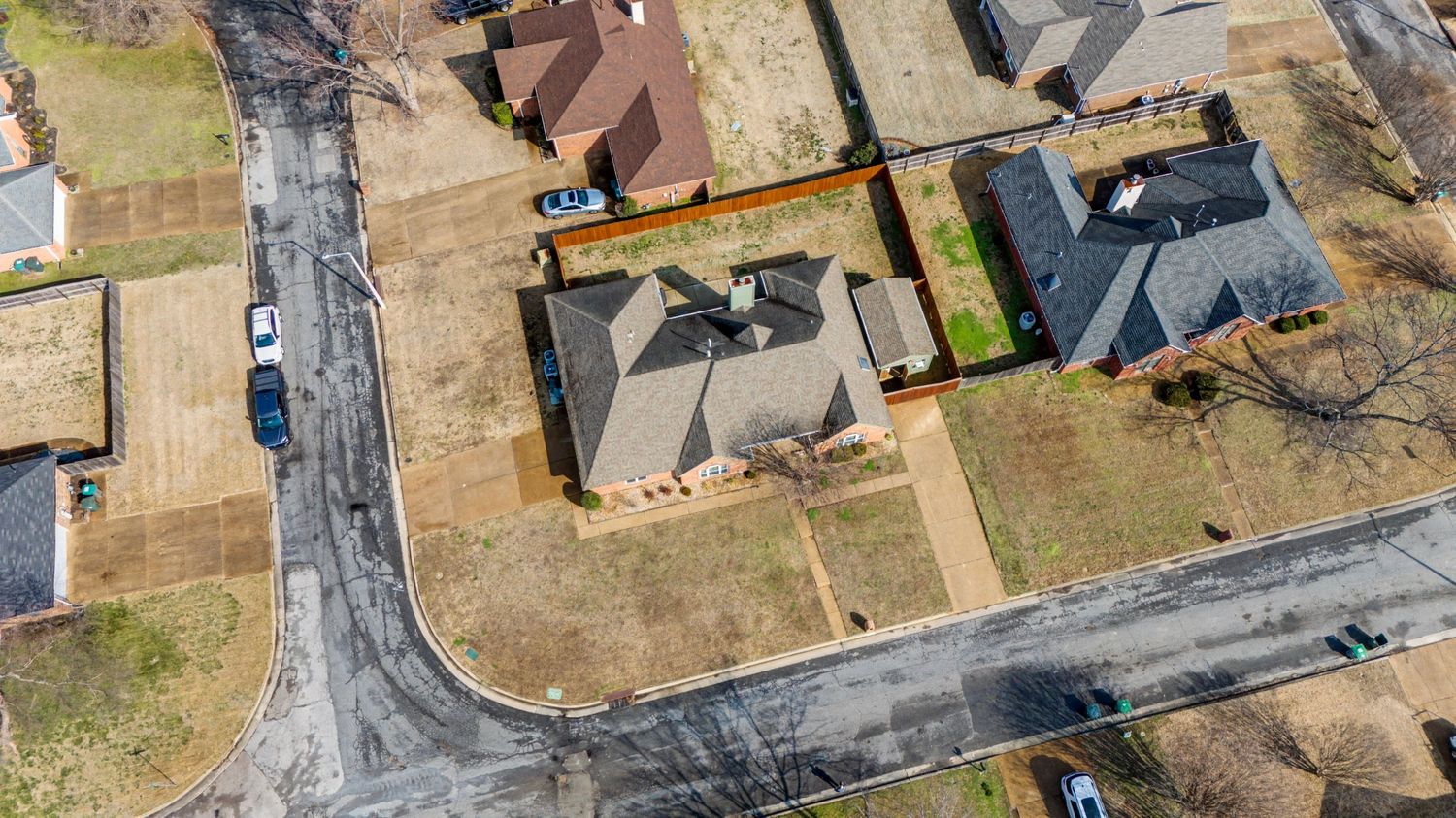 Aerial view of a residential neighborhood with houses and streets in a suburban development during winter.