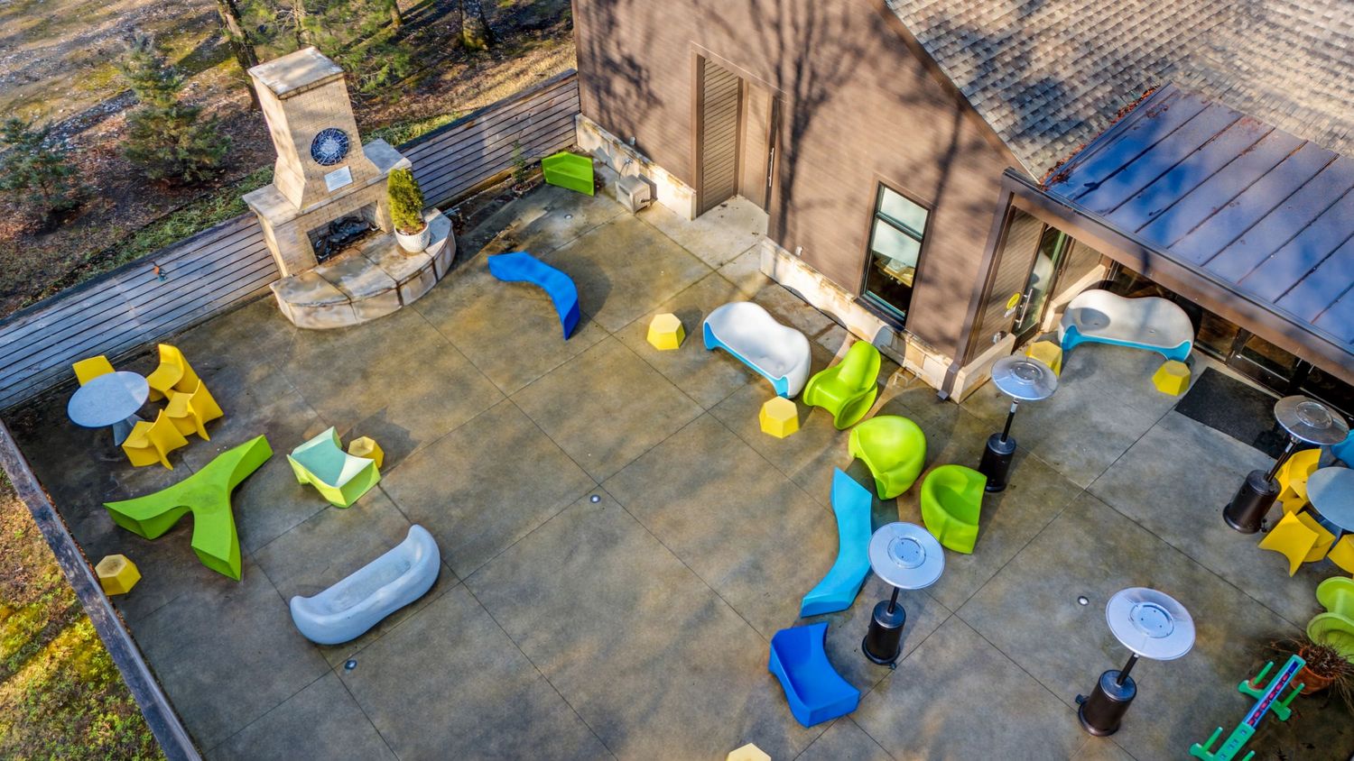 Aerial view of a construction site with workers assembling scaffolding and equipment on a concrete foundation.