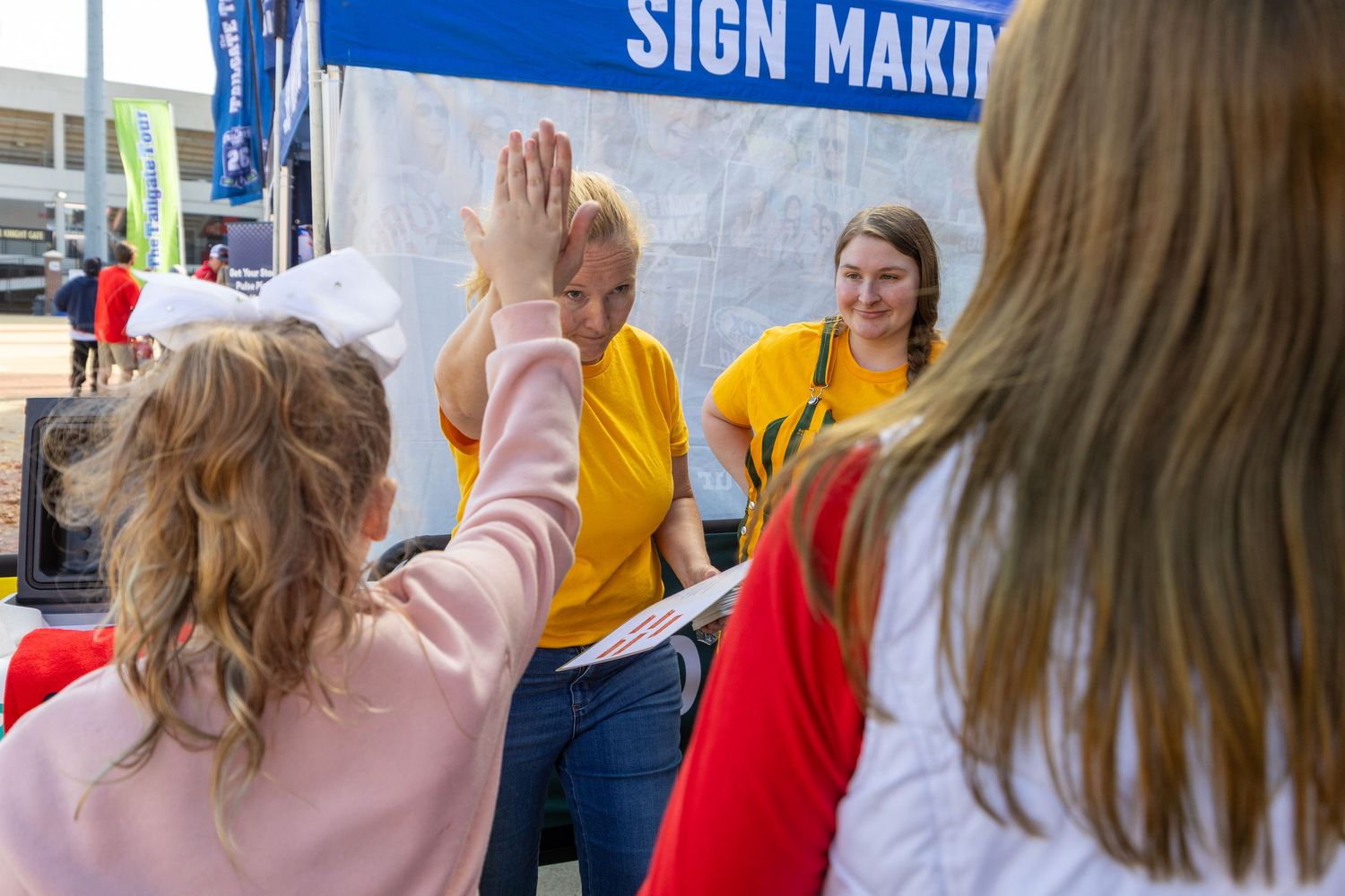 Students participate in a sign making activity with colorful craft materials and supplies.