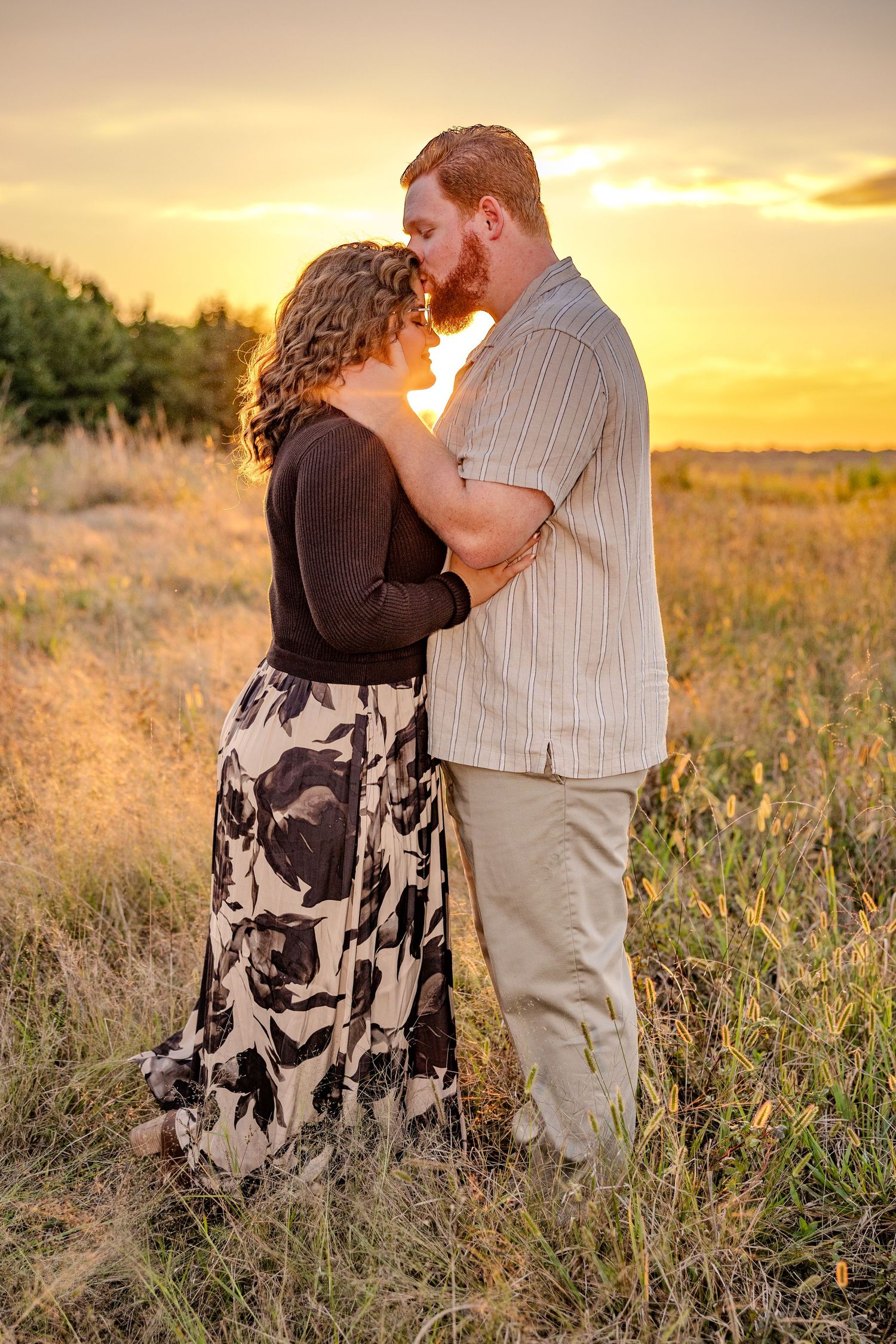 Romantic sunset embrace in a golden field.