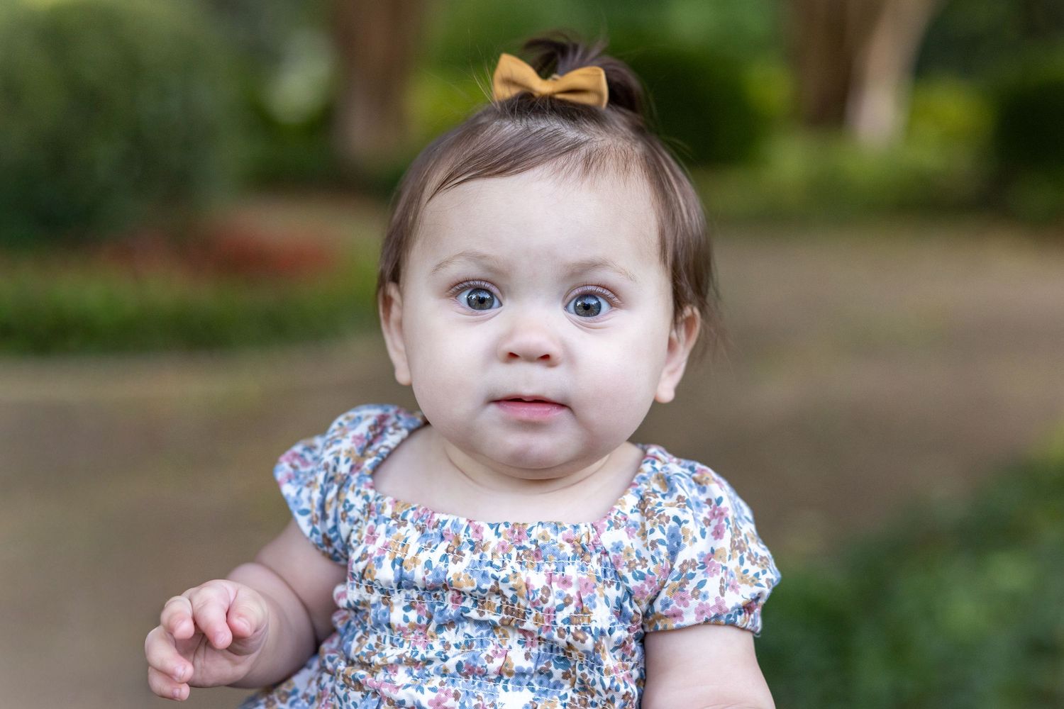 Close-up portrait shots in an outdoor park setting with natural lighting.