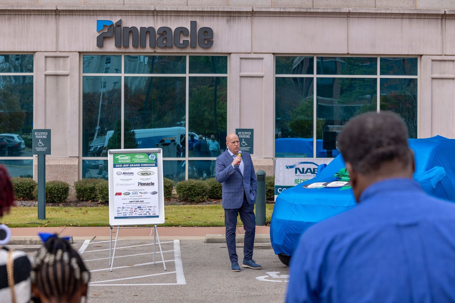 Exterior view of Pinnacle office building with people gathered outside.