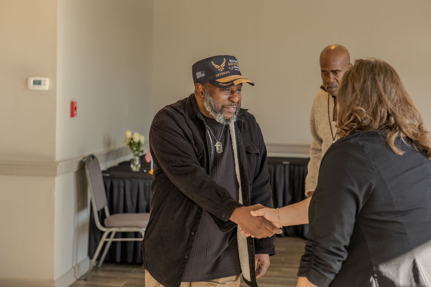 People greeting and shaking hands at a professional networking event.